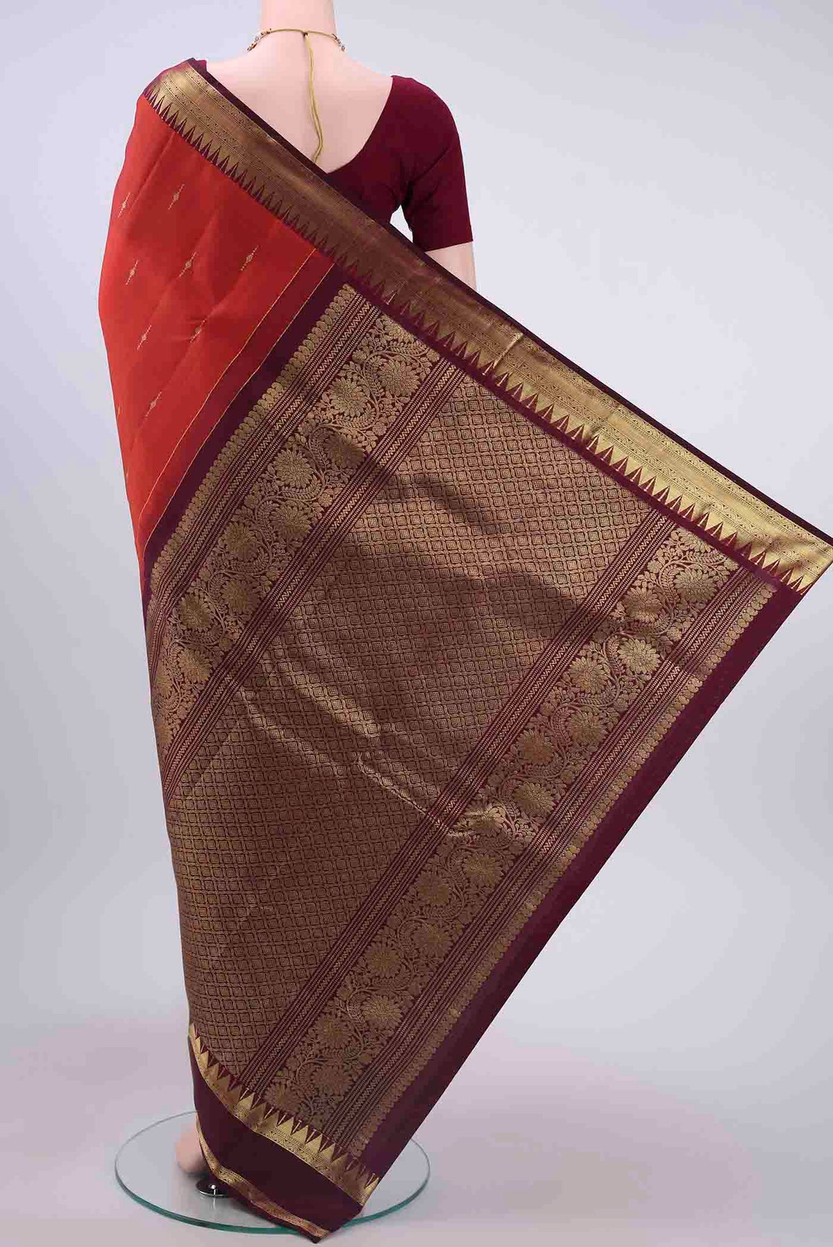 Flat view of Rust Kanchipuram Silk Saree with Zari Butta on the body and Zari Border