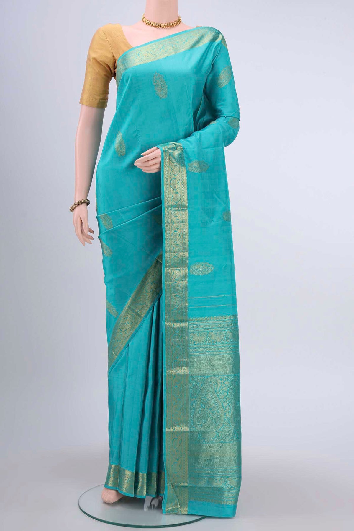 Blue Kanchipuram Silk Saree with Zari Butta on the body and Zari Border displayed on a mannequin