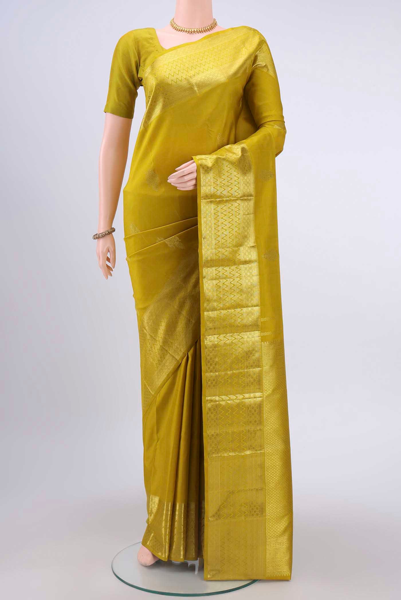 Acid Green Kanchipuram Saree with Zari Butta on the body and Zari Border displayed on a mannequin
