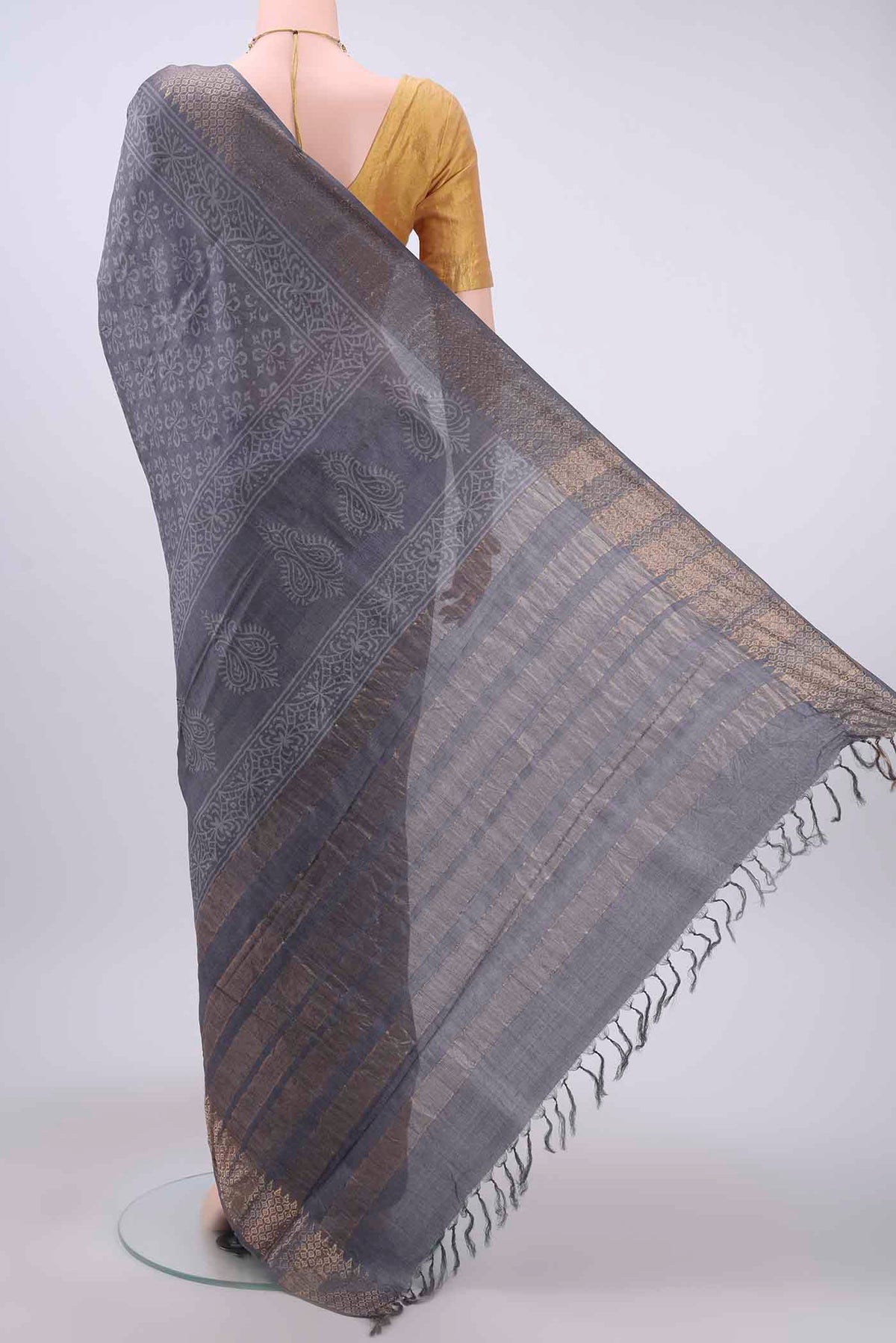 Flat view of Grey Tussar Silk Saree with Printed design on the body and Zari Border