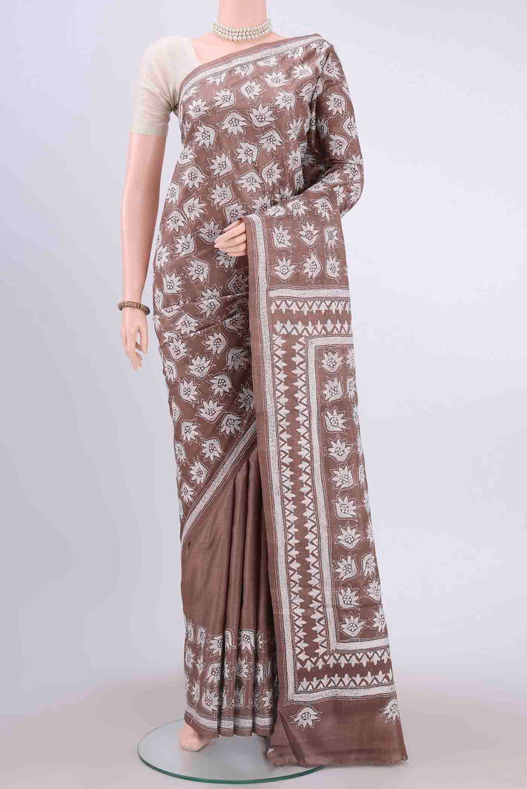 Brown Kantha Silk Saree with Kantha Work on the body and Thread Border displayed on a mannequin