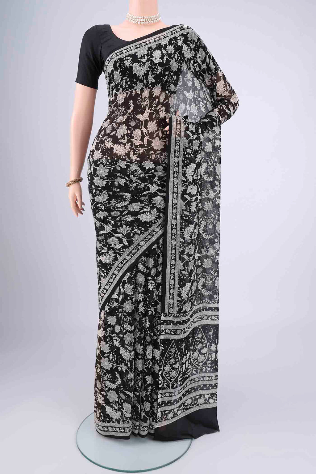 Black Mysore Chiffon Saree with Floral Print on the body and Zari Border.  displayed on a mannequin