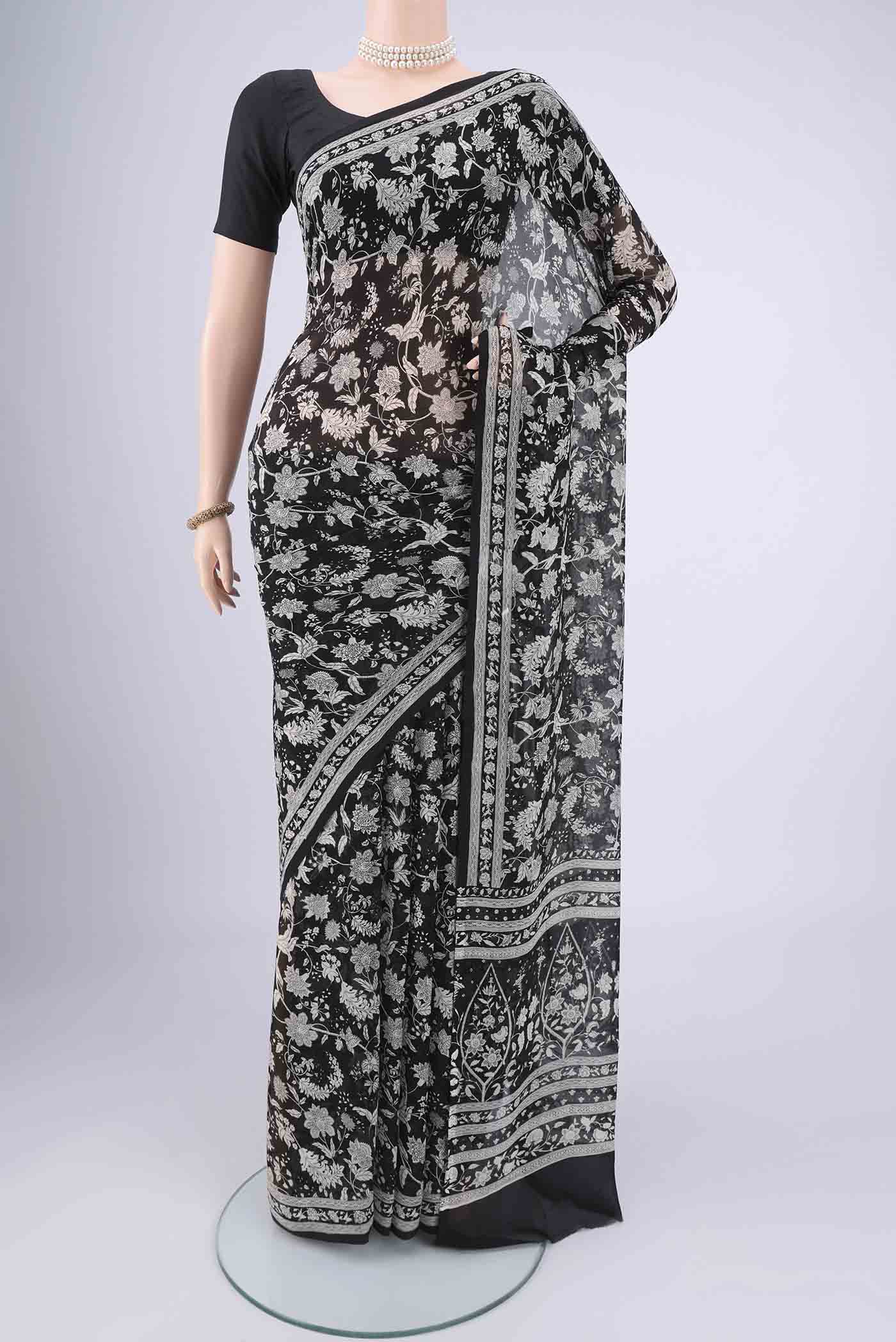 Black Mysore Chiffon Saree with Floral Print on the body and Zari Border.  displayed on a mannequin