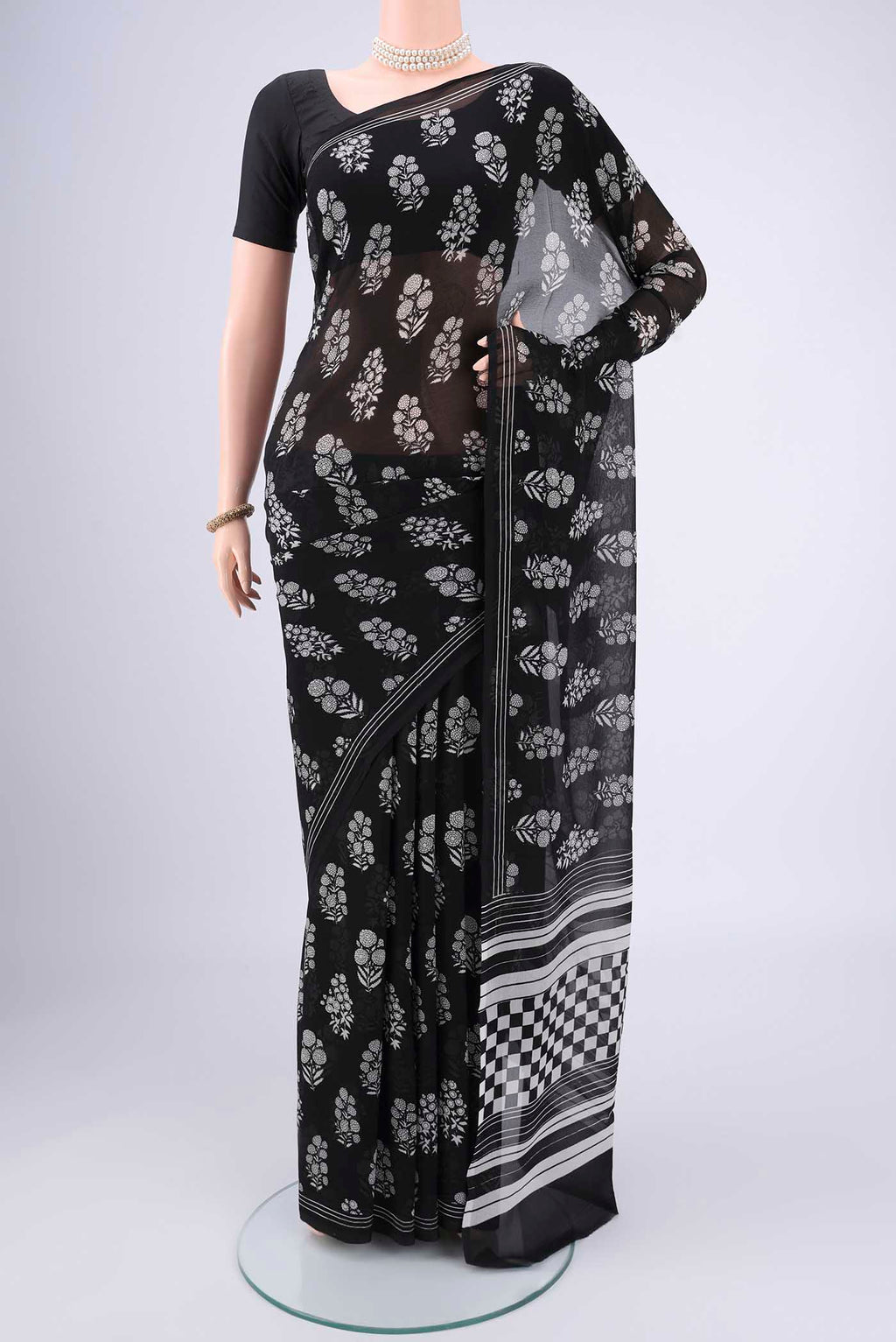 Black Mysore Chiffon Saree with Floral Print on the body and Plain Border.  displayed on a mannequin