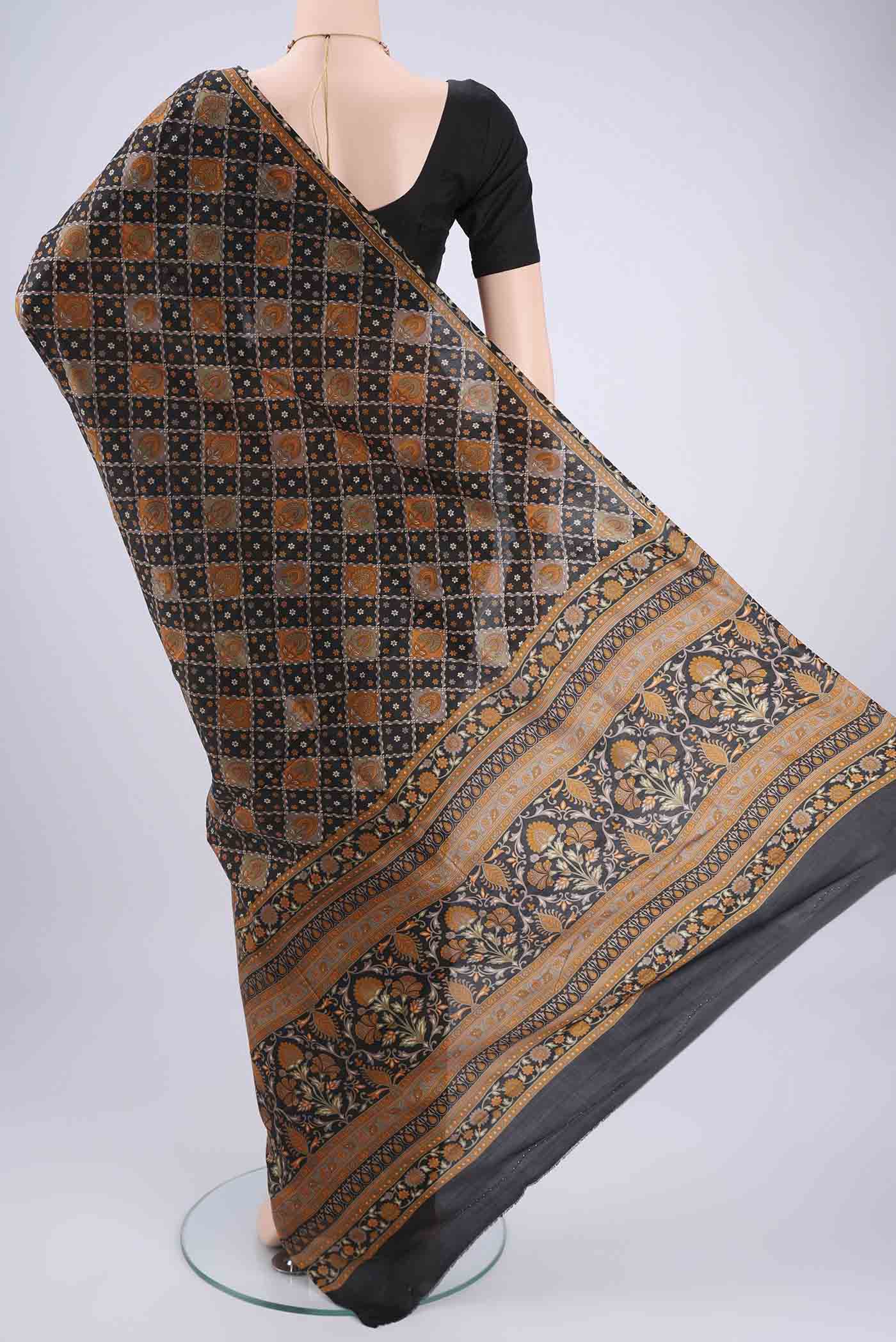 Flat view of Black Printed Silk Saree with Floral Print on the body and Printed Border. 