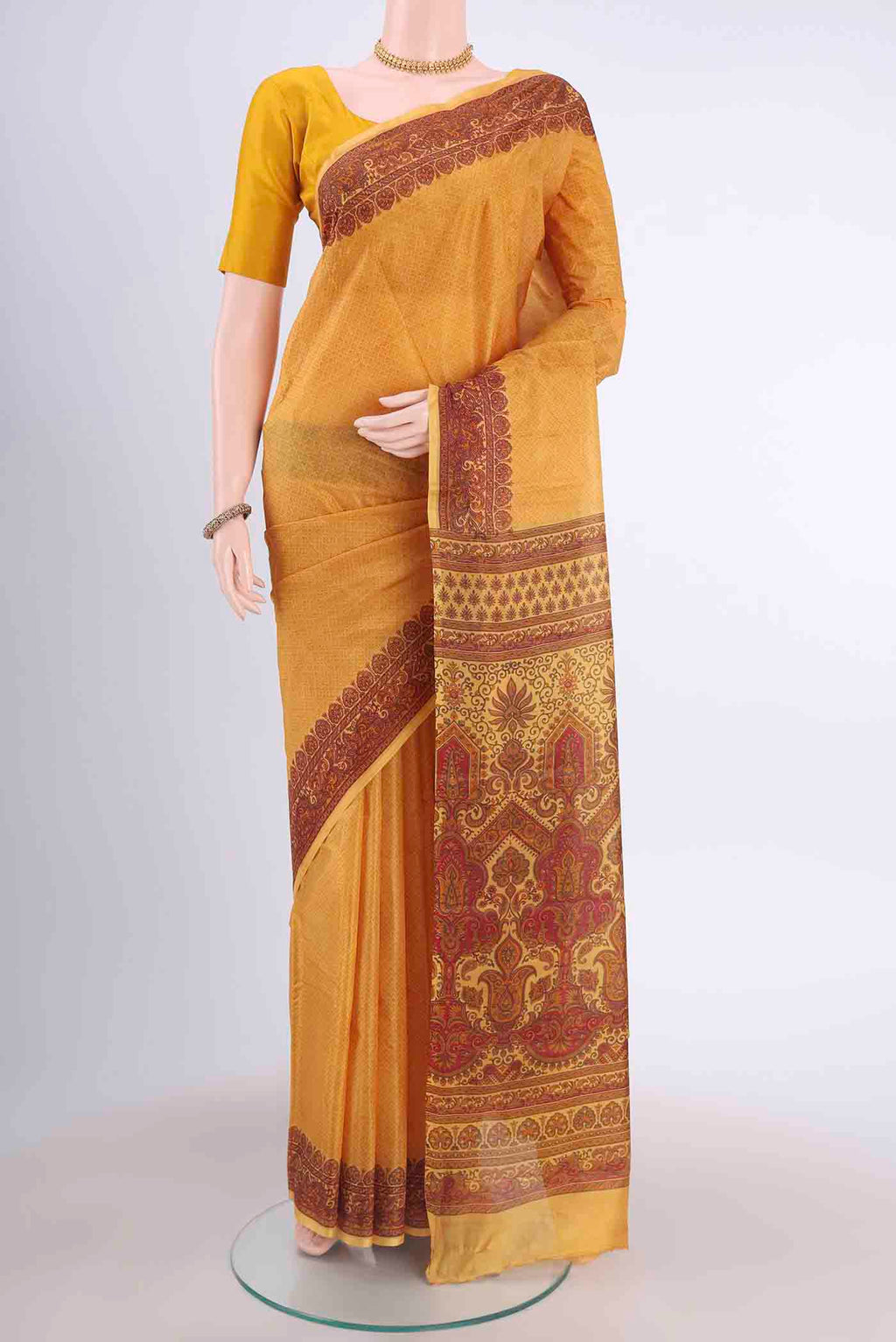 Mustard Printed Silk Saree with Floral Print on the body and Printed Border displayed on a mannequin
