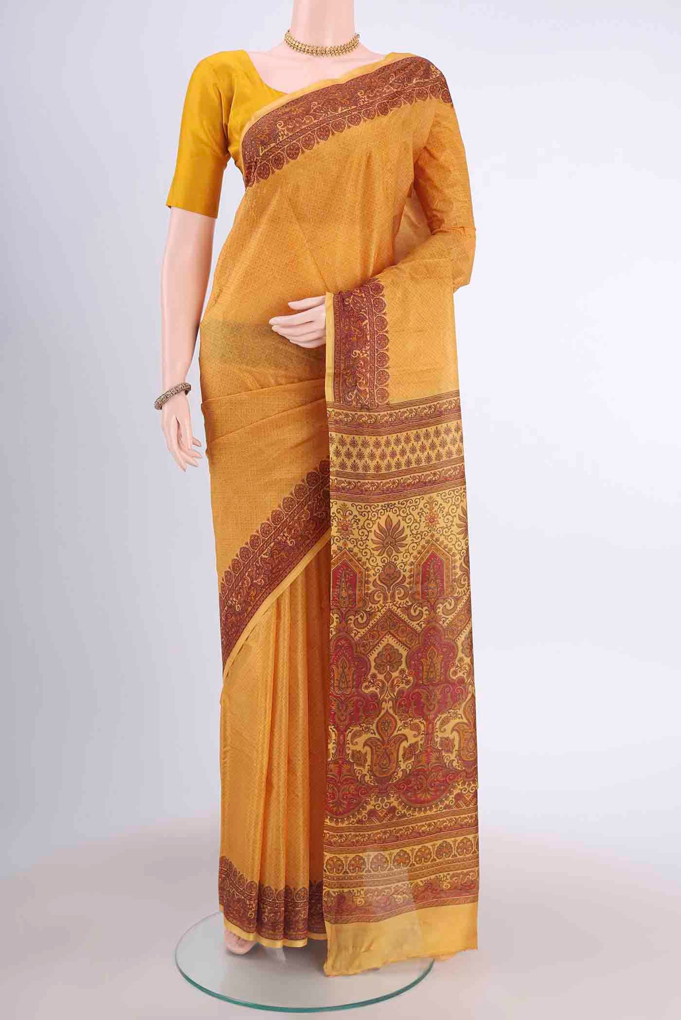 Mustard Printed Silk Saree with Floral Print on the body and Printed Border displayed on a mannequin