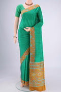 Green Printed Silk Saree with Floral Print on the body and Printed Border.  displayed on a mannequin