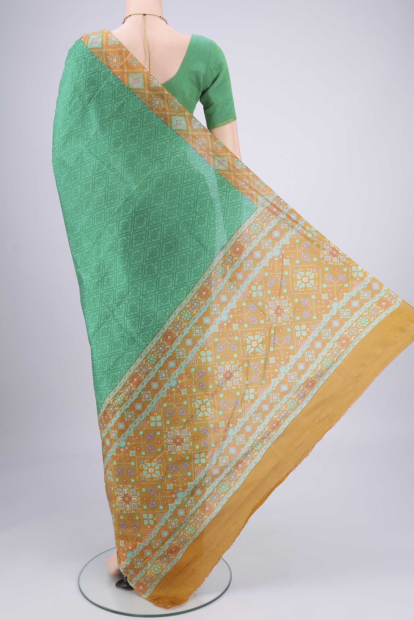 Flat view of Green Printed Silk Saree with Floral Print on the body and Printed Border. 