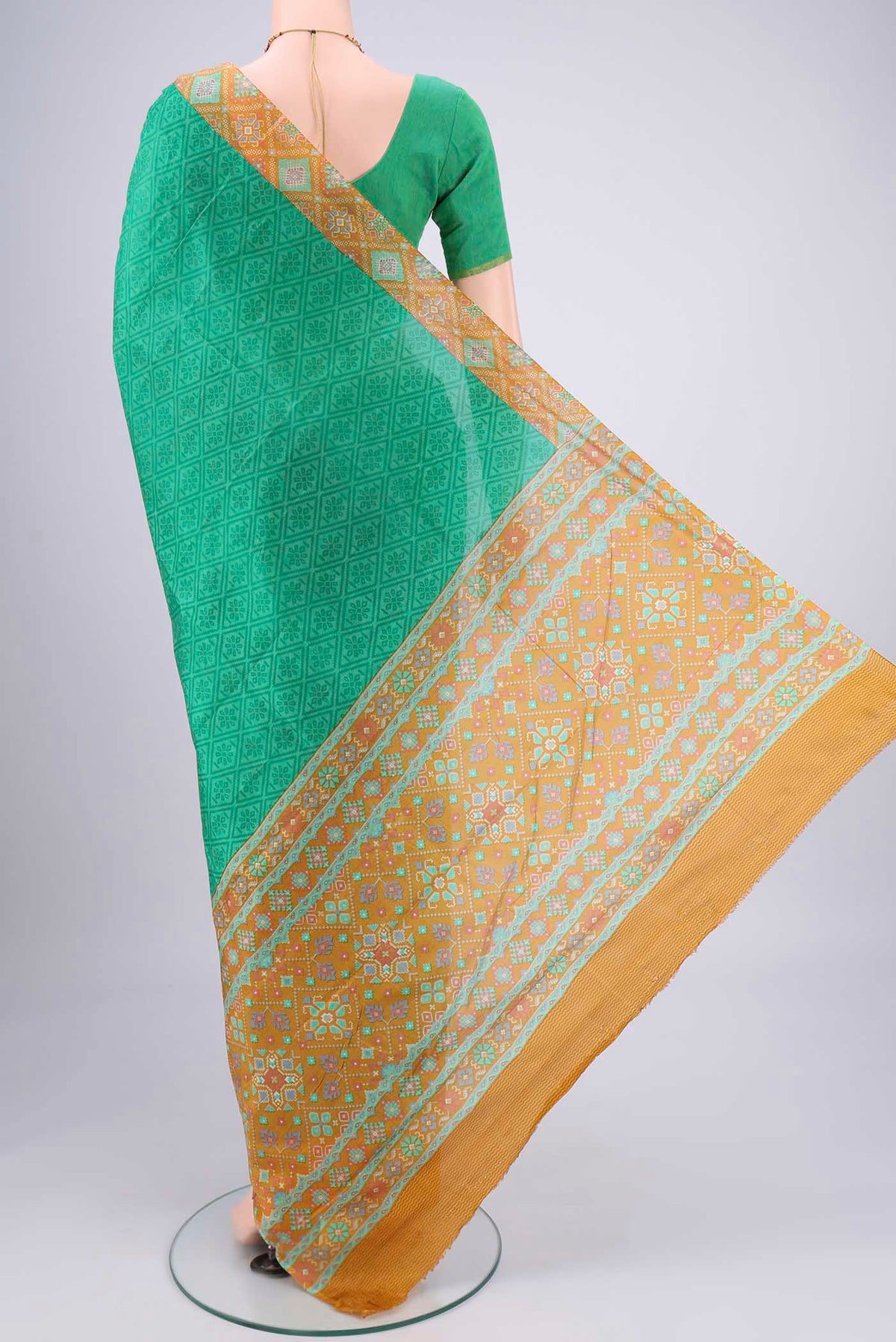 Flat view of Green Printed Silk Saree with Floral Print on the body and Printed Border. 