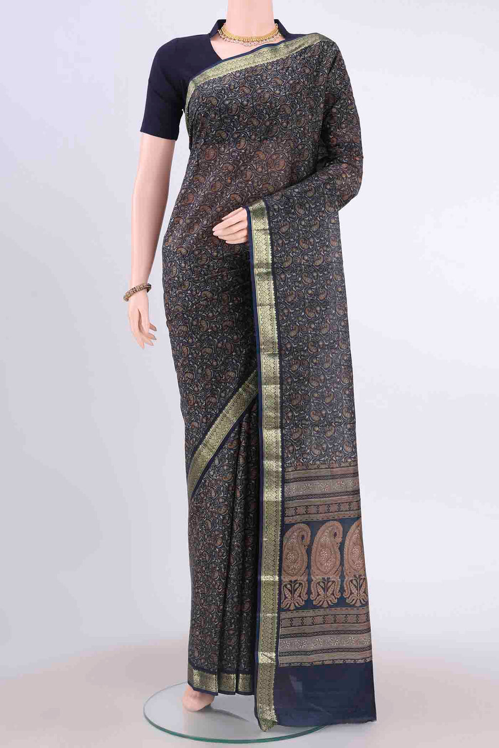 Navy Blue Printed Silk Saree with Floral Print on the body and Zari Border displayed on a mannequin
