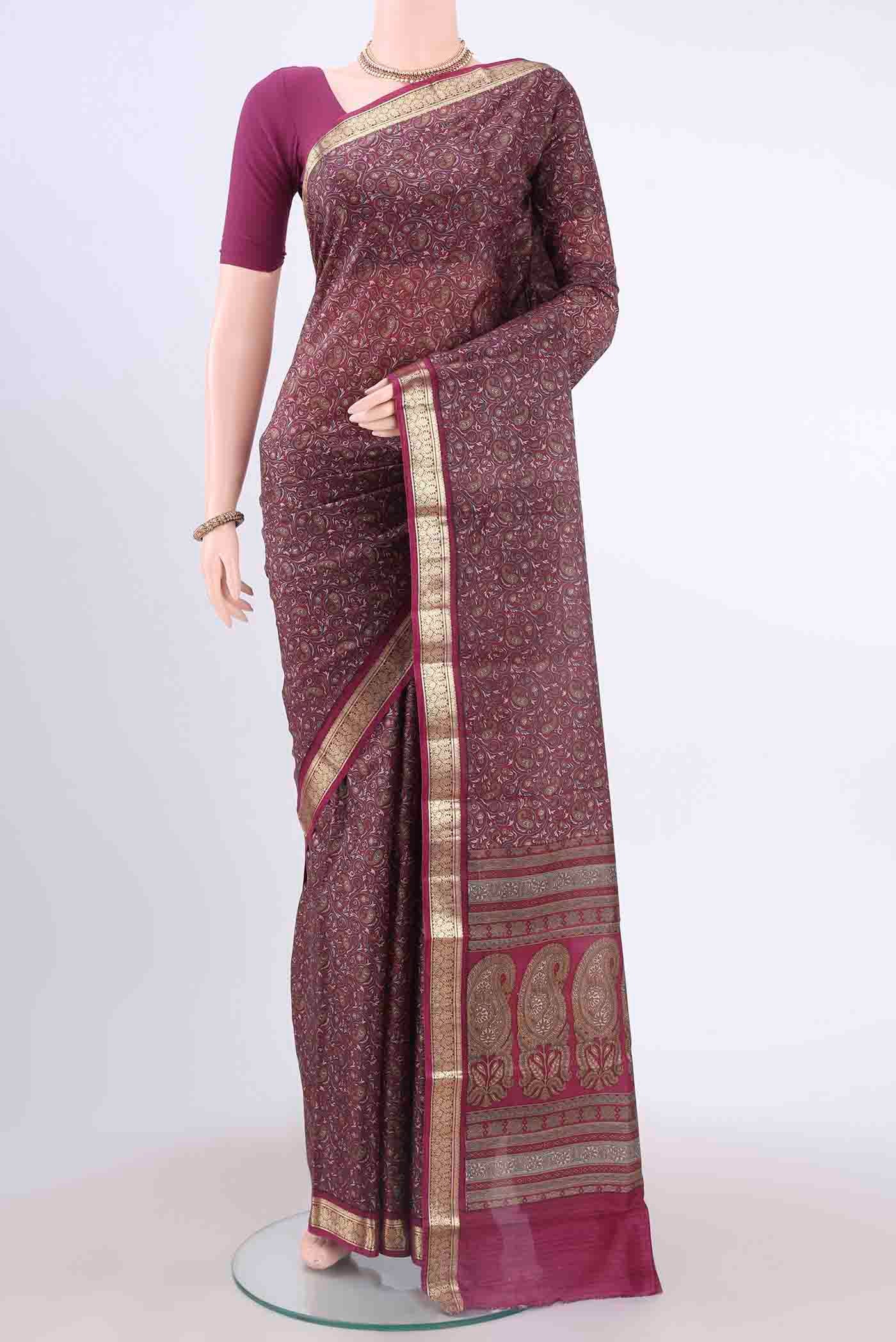 Magenta Printed Silk Saree with Floral Print on the body and Zari Border displayed on a mannequin