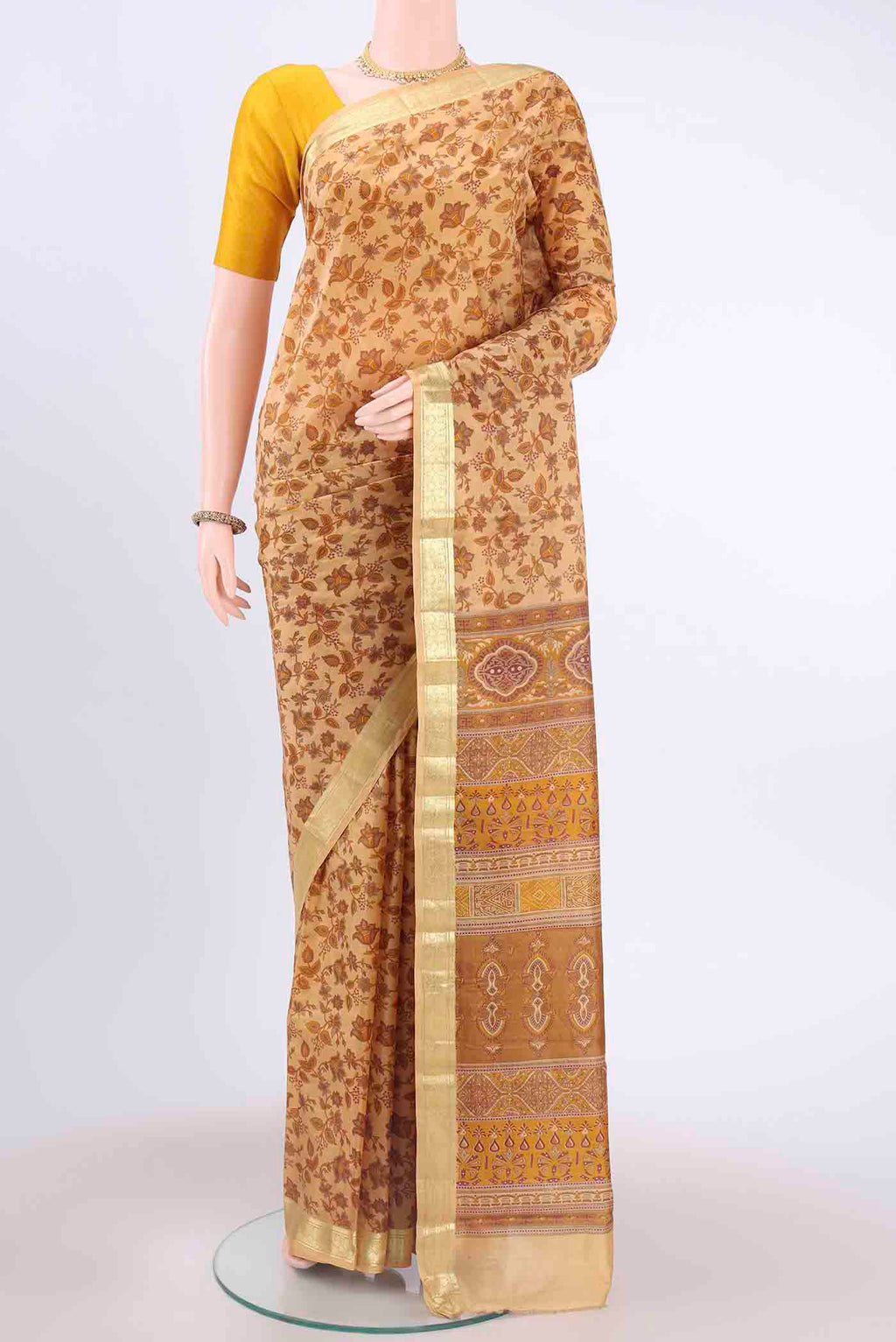 Cream Printed Silk Saree with Floral Print on the body and Zari Border displayed on a mannequin