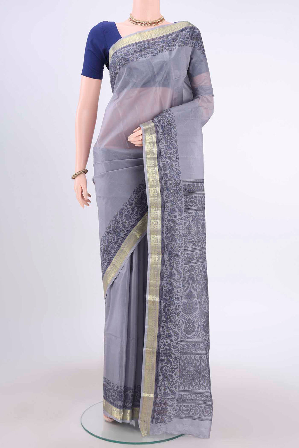 Blue Grey Printed Silk Saree with Floral Print on the body and Zari Border displayed on a mannequin