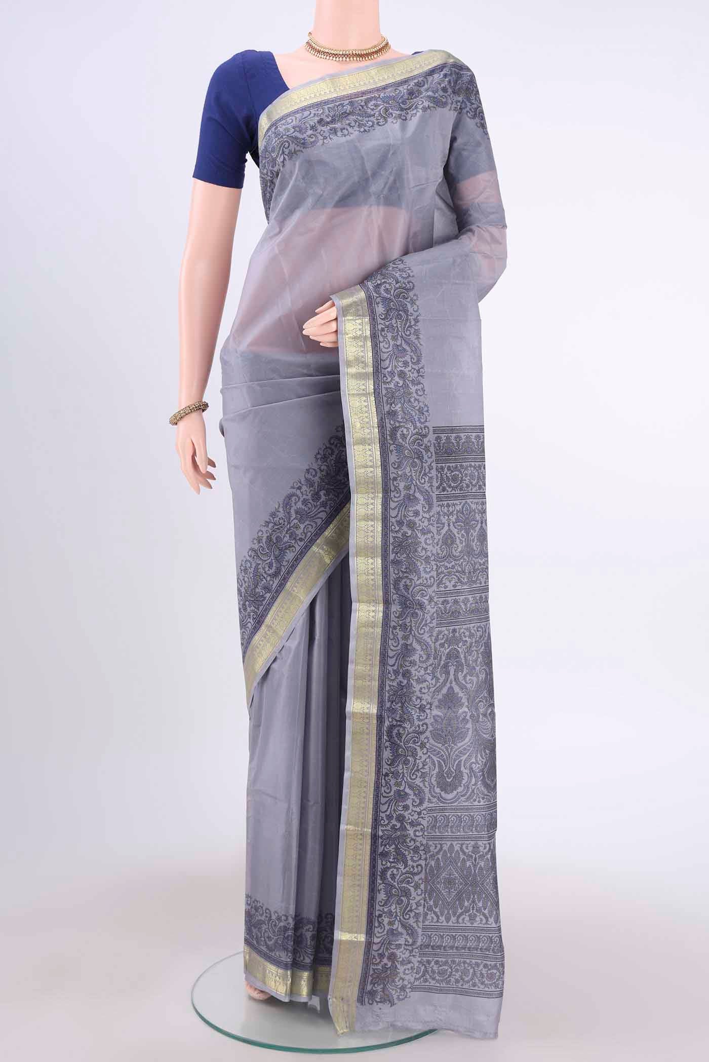 Blue Grey Printed Silk Saree with Floral Print on the body and Zari Border displayed on a mannequin
