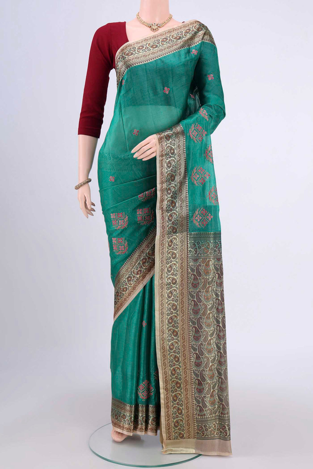Sea Green Banarasi Tussar Silk Saree with Zari Butta on the body and Zari Border.  displayed on a mannequin