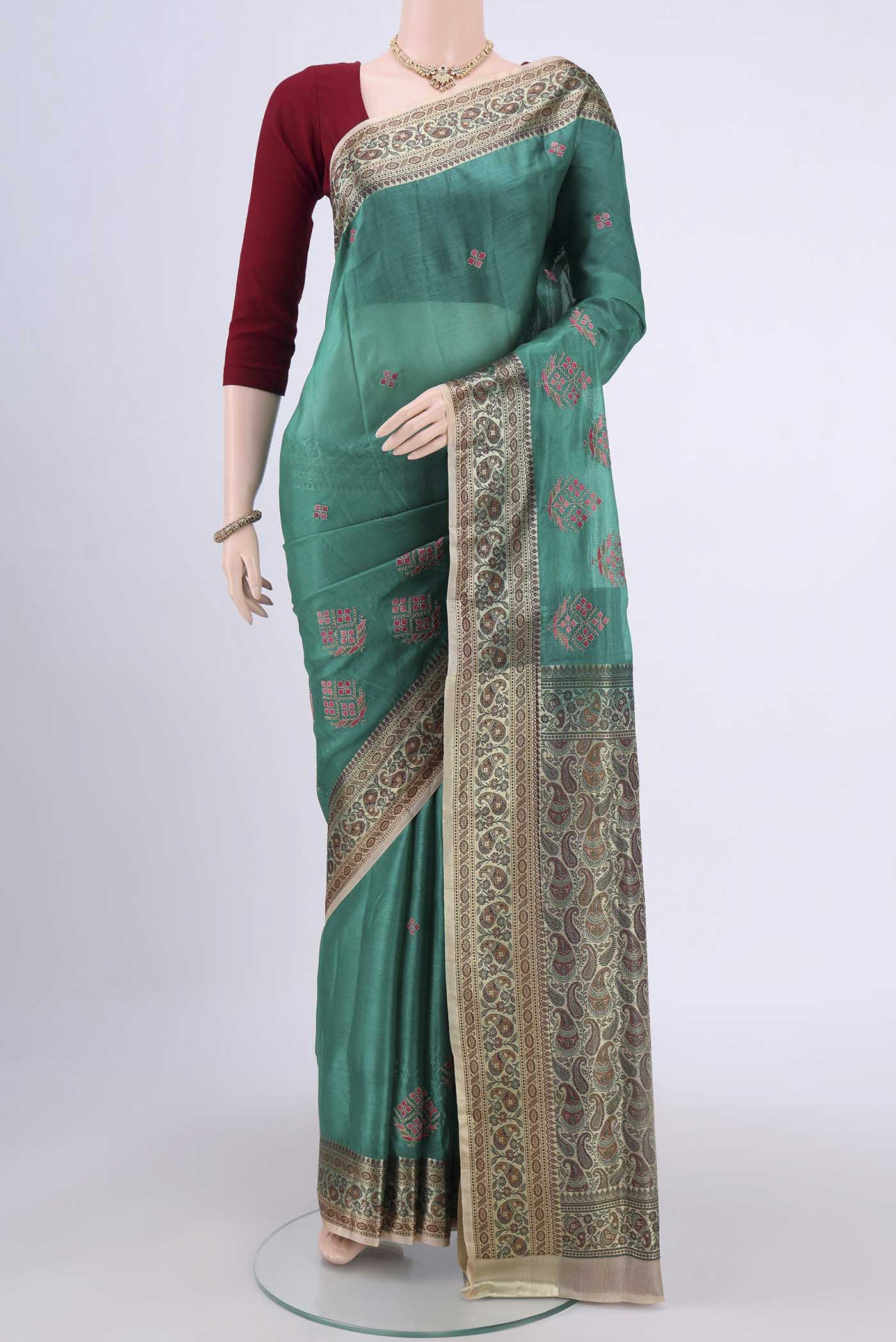 Sea Green Banarasi Tussar Silk Saree with Zari Butta on the body and Zari Border.  displayed on a mannequin