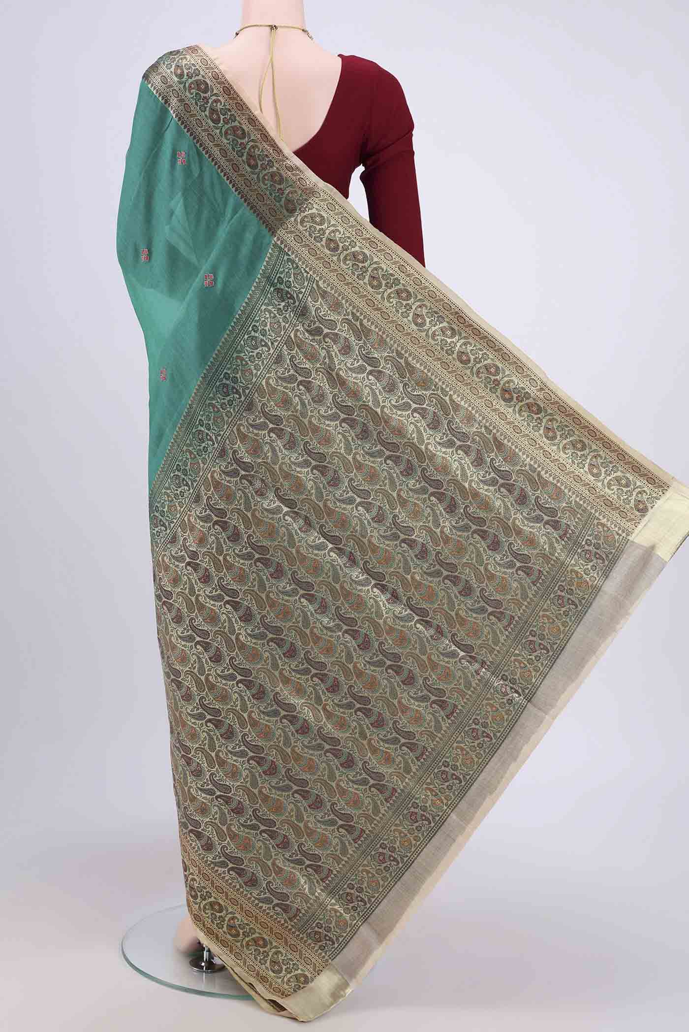 Flat view of Sea Green Banarasi Tussar Silk Saree with Zari Butta on the body and Zari Border. 