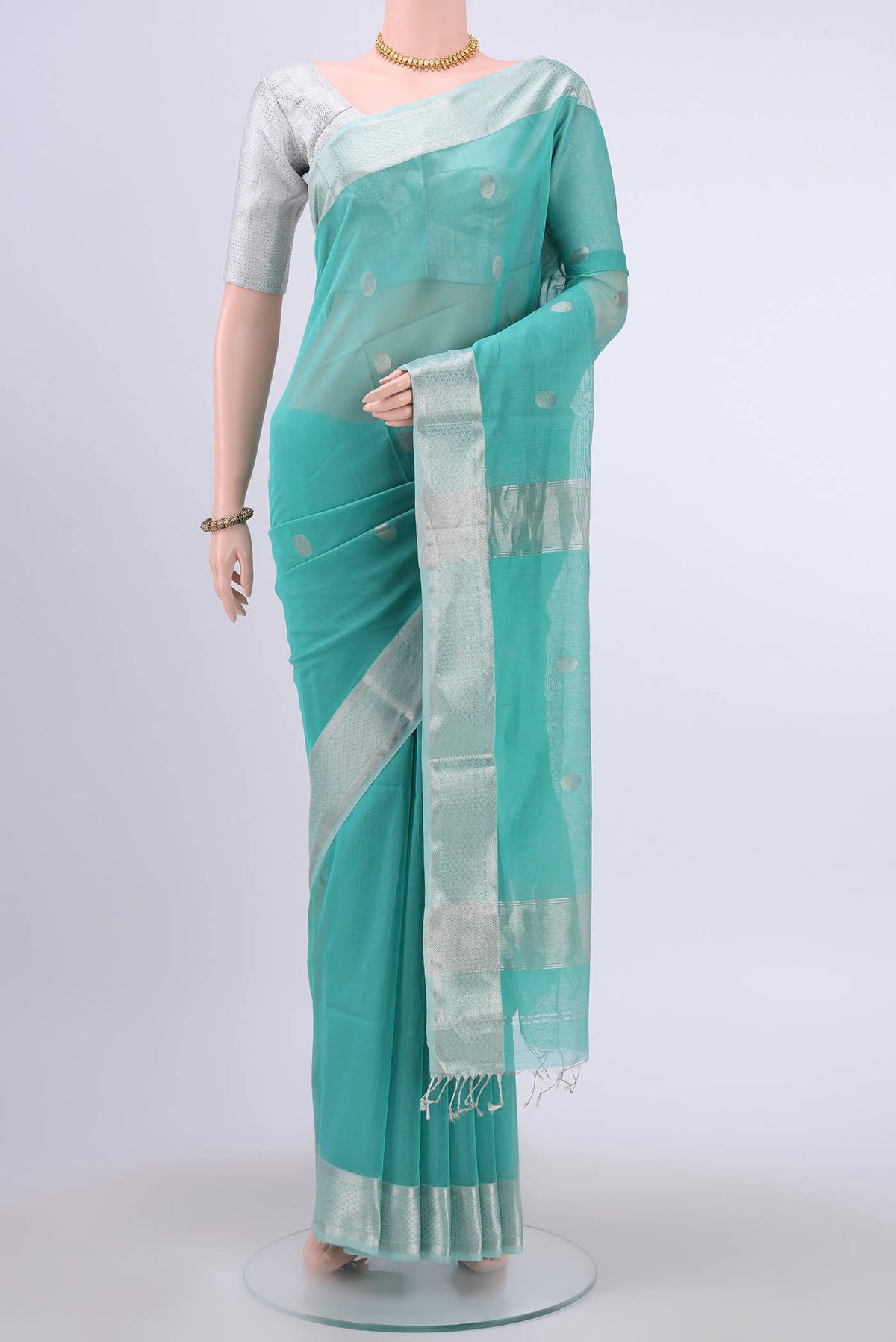 Turquoise Maheshwari Silk Cotton Saree with Zari Butta on the body and Zari Border displayed on a mannequin