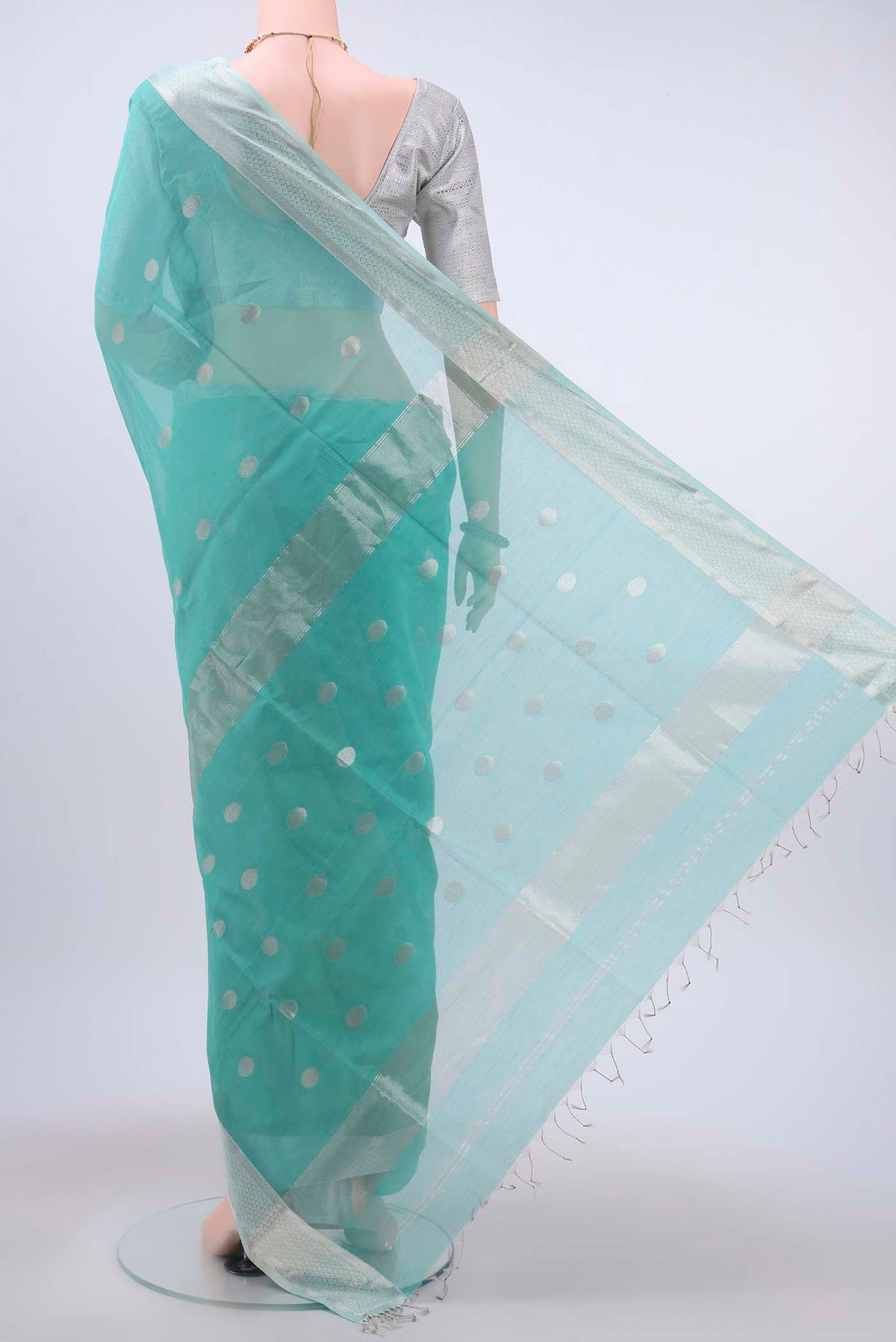 Flat view of Turquoise Maheshwari Silk Cotton Saree with Zari Butta on the body and Zari Border