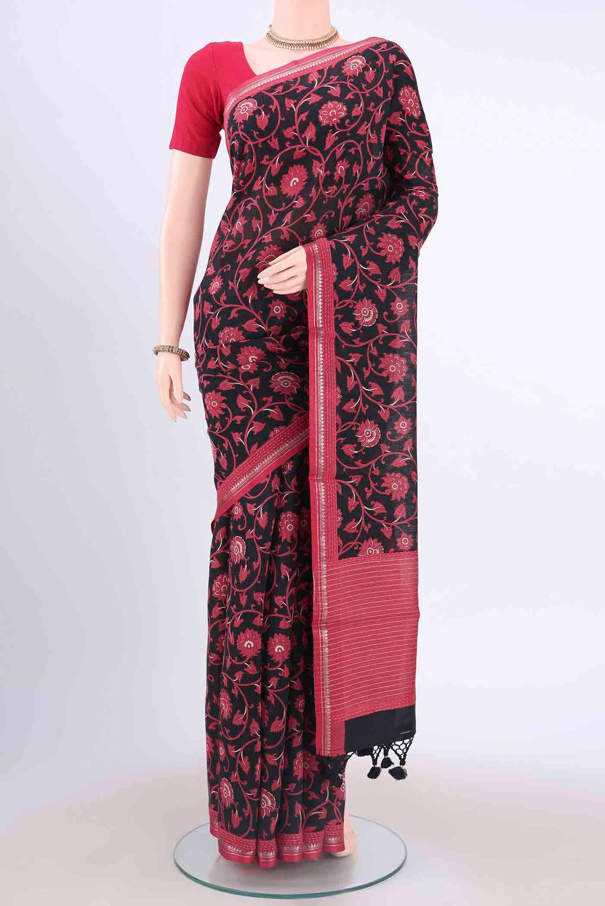 Black Dual Tone Tussar Silk Saree with Printed design on the body and Zari And Thread Border displayed on a mannequin