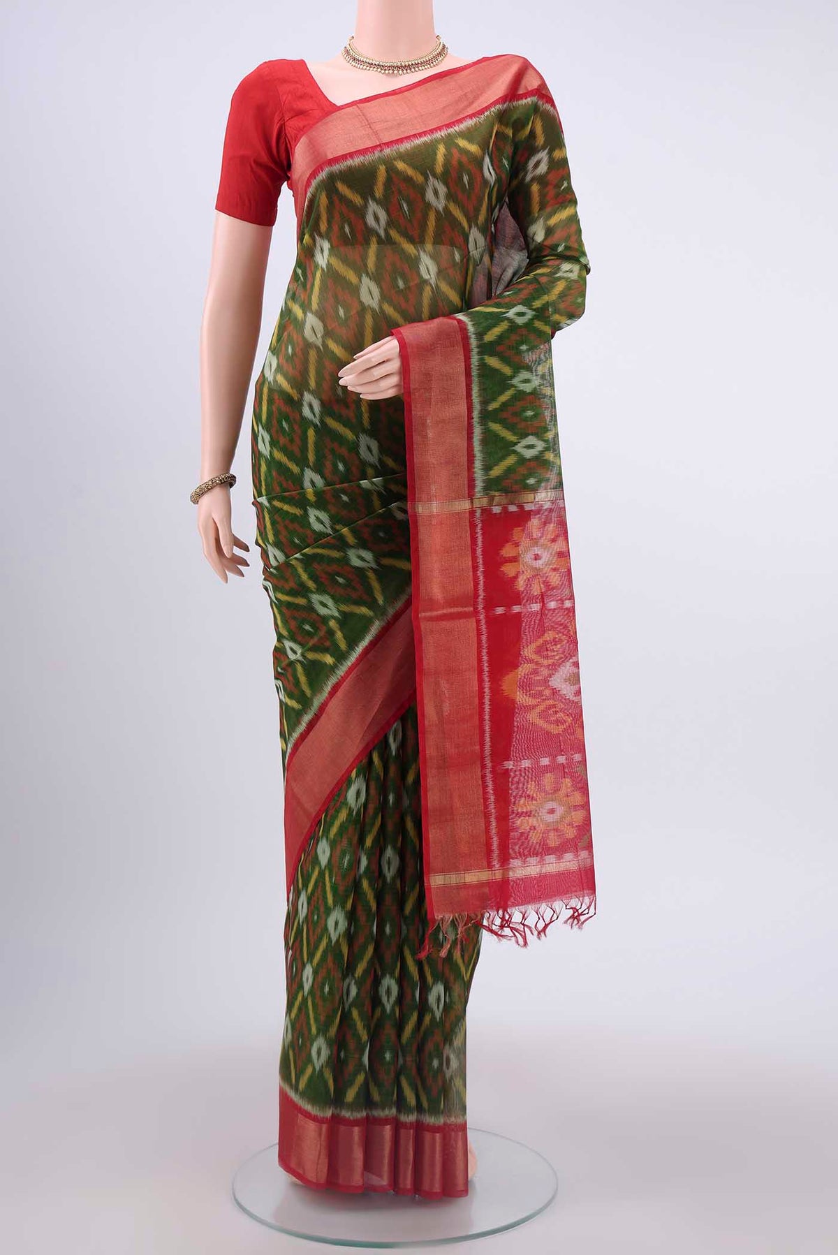 Mehandi Green Kora Cotton Saree with Ikat design on the body and Zari Border displayed on a mannequin