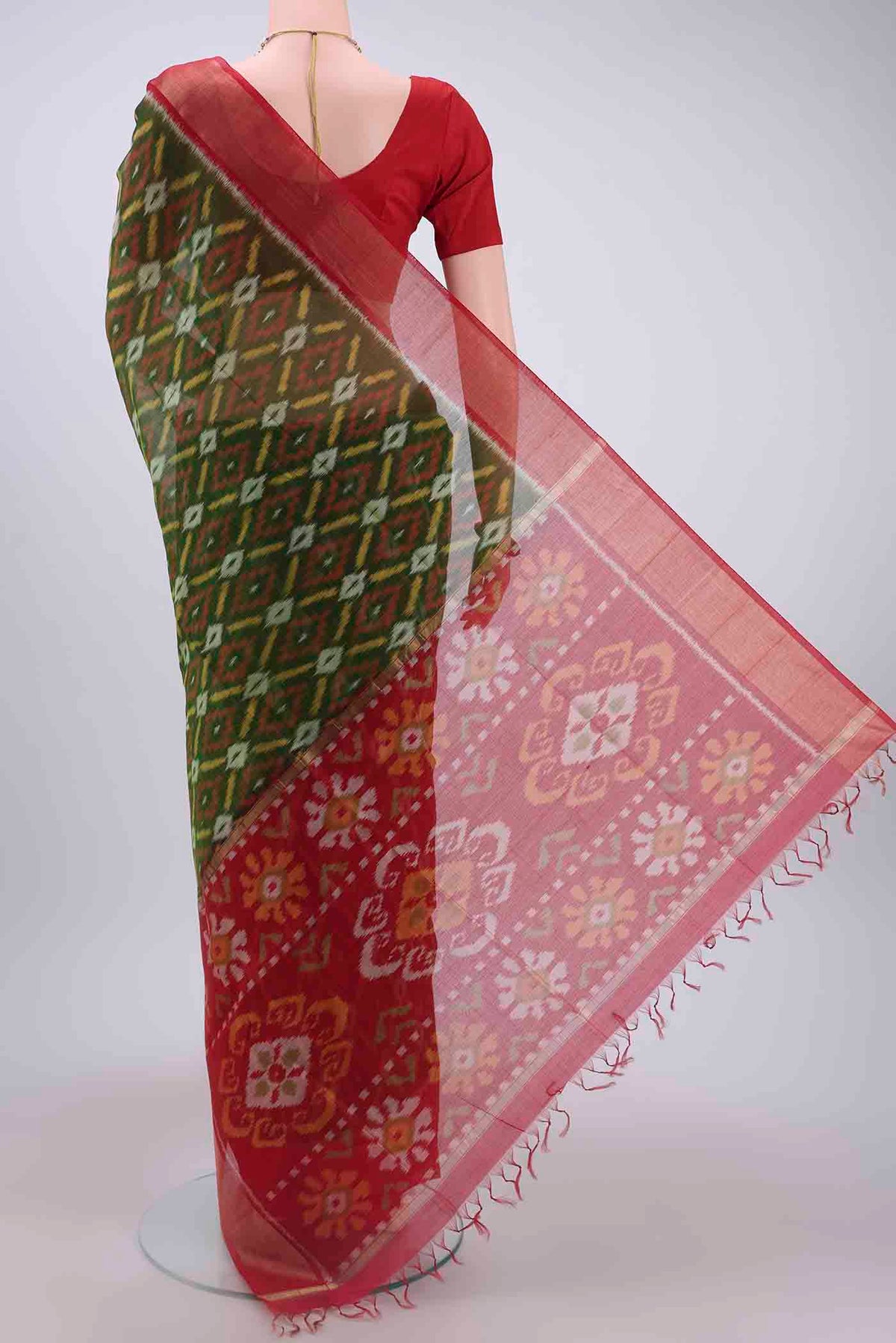 Flat view of Mehandi Green Kora Cotton Saree with Ikat design on the body and Zari Border
