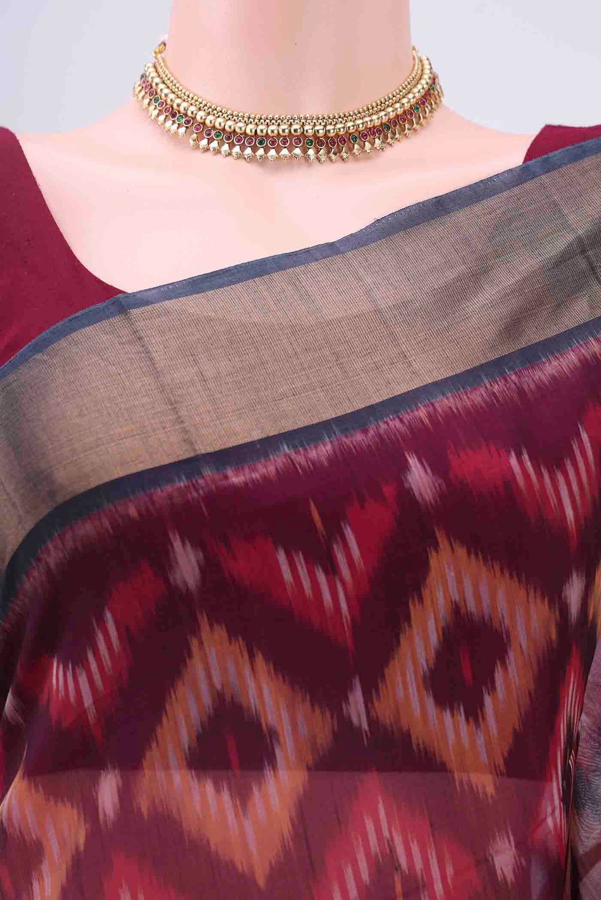 Border image of Maroon Kora Cotton Saree with Ikat design on the body and Zari Border