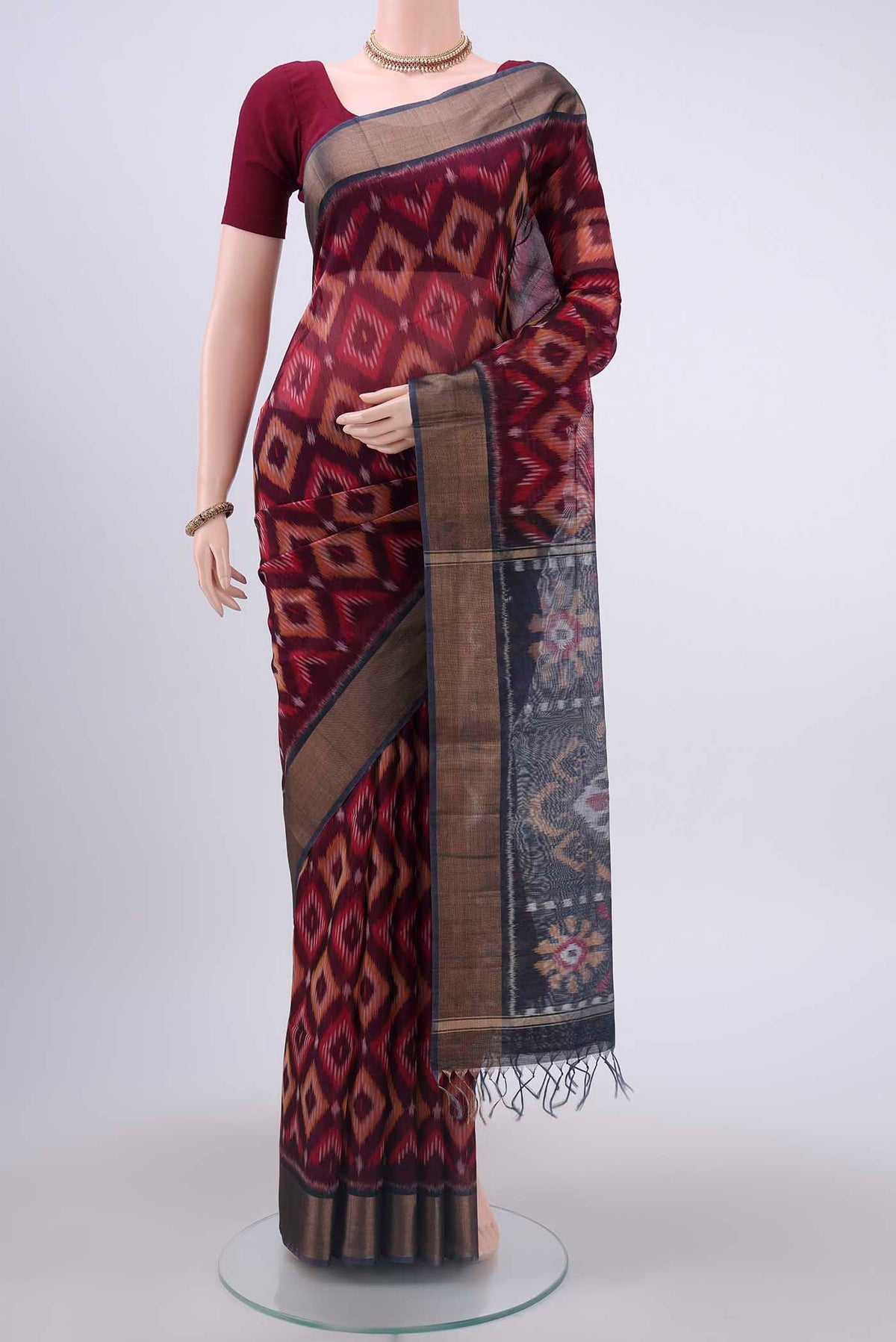 Maroon Kora Cotton Saree with Ikat design on the body and Zari Border displayed on a mannequin
