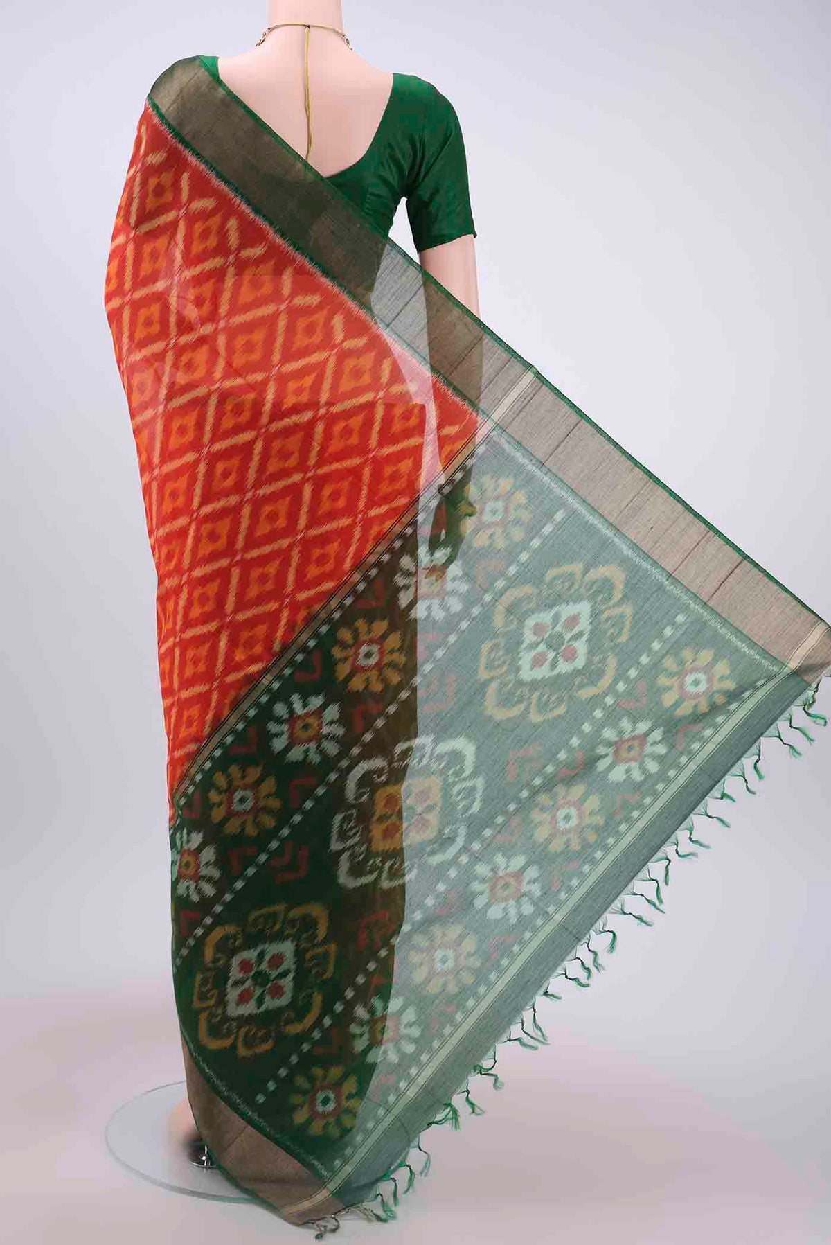Flat view of Brick Orange Kora Cotton Saree with Ikat design on the body and Zari Border