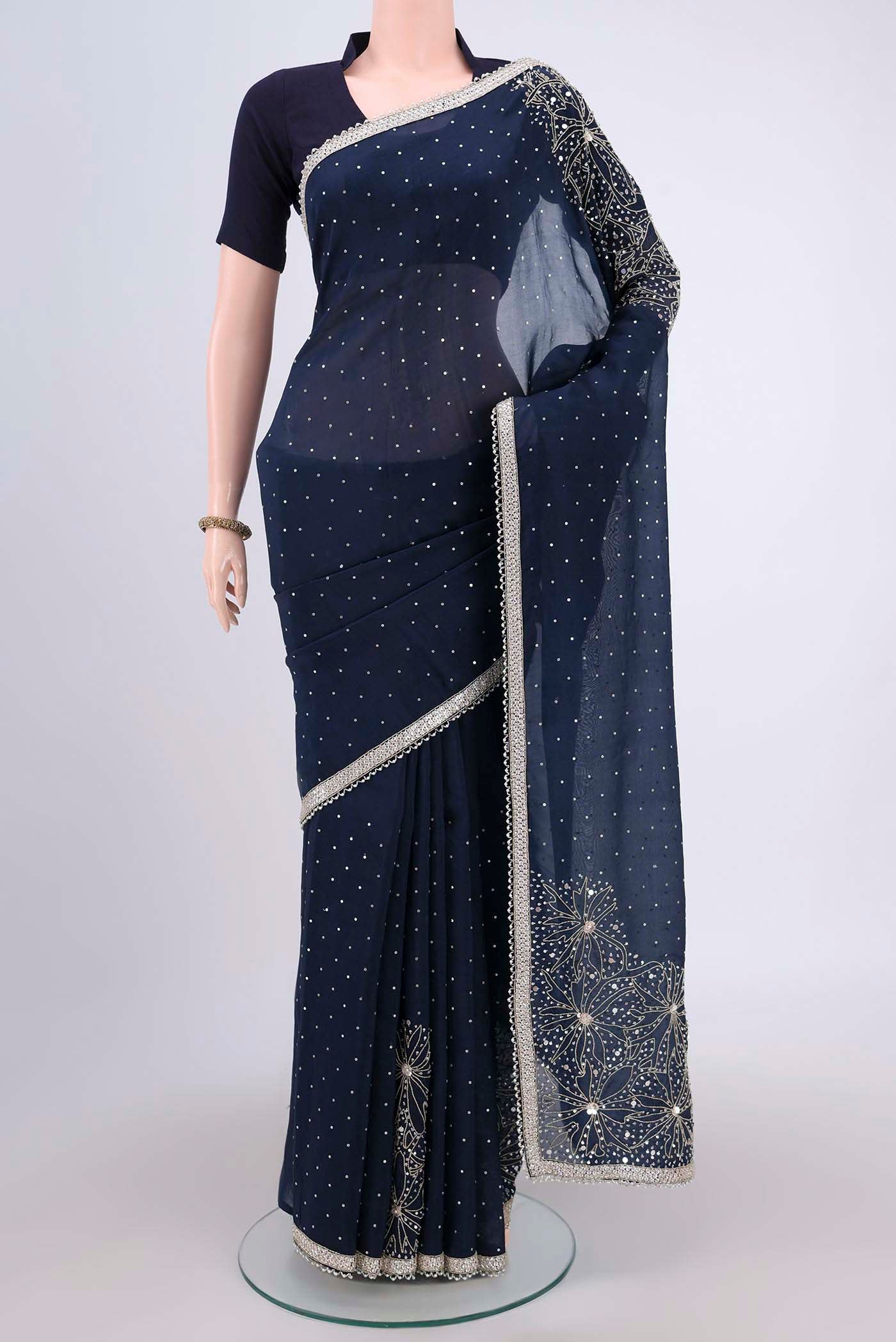 Navy Blue Organza Silk Saree with Embroidery on the body and Zari Border.  displayed on a mannequin