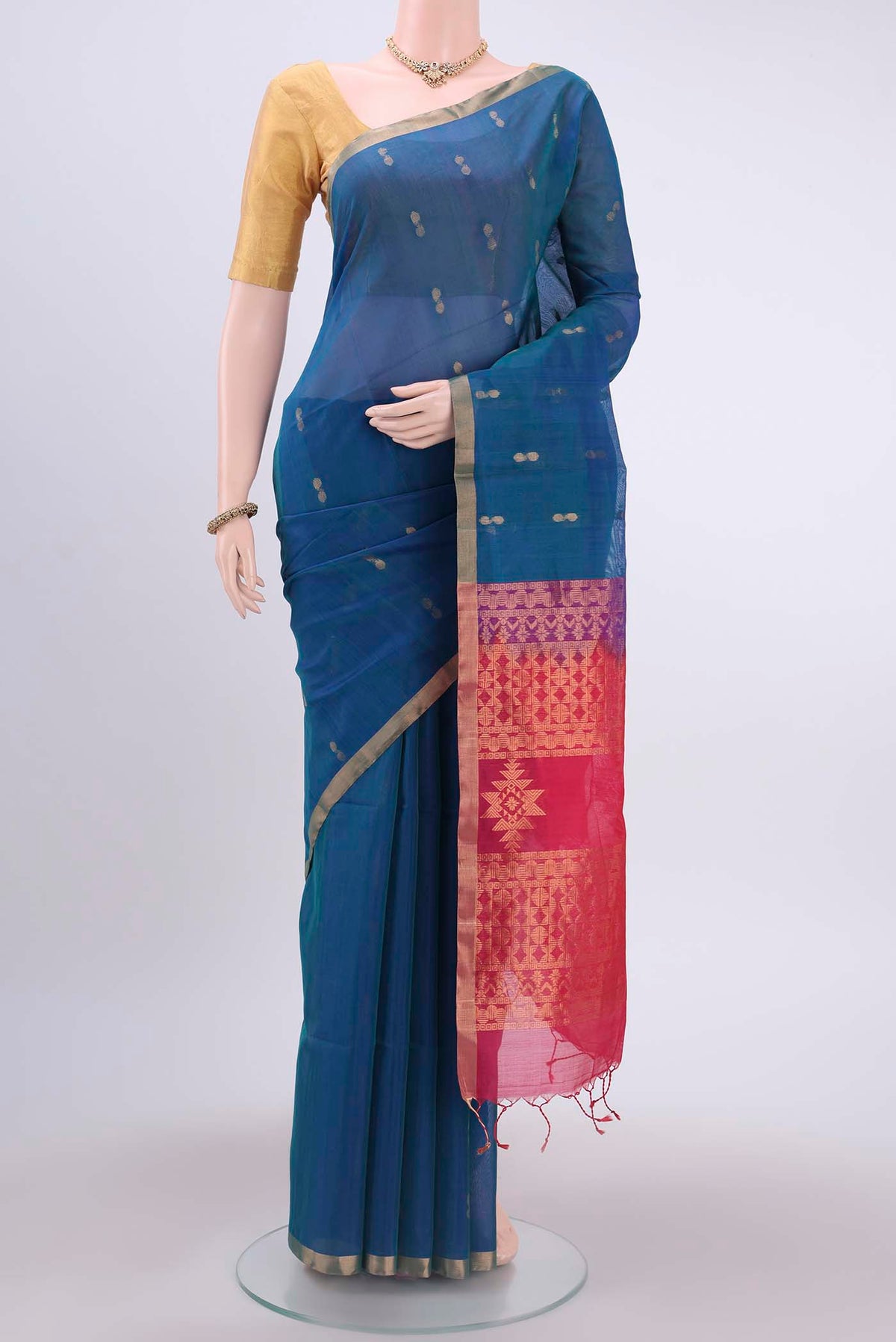 Peacock Blue Kora Cotton Saree with Zari Butta on the body and Zari Border displayed on a mannequin