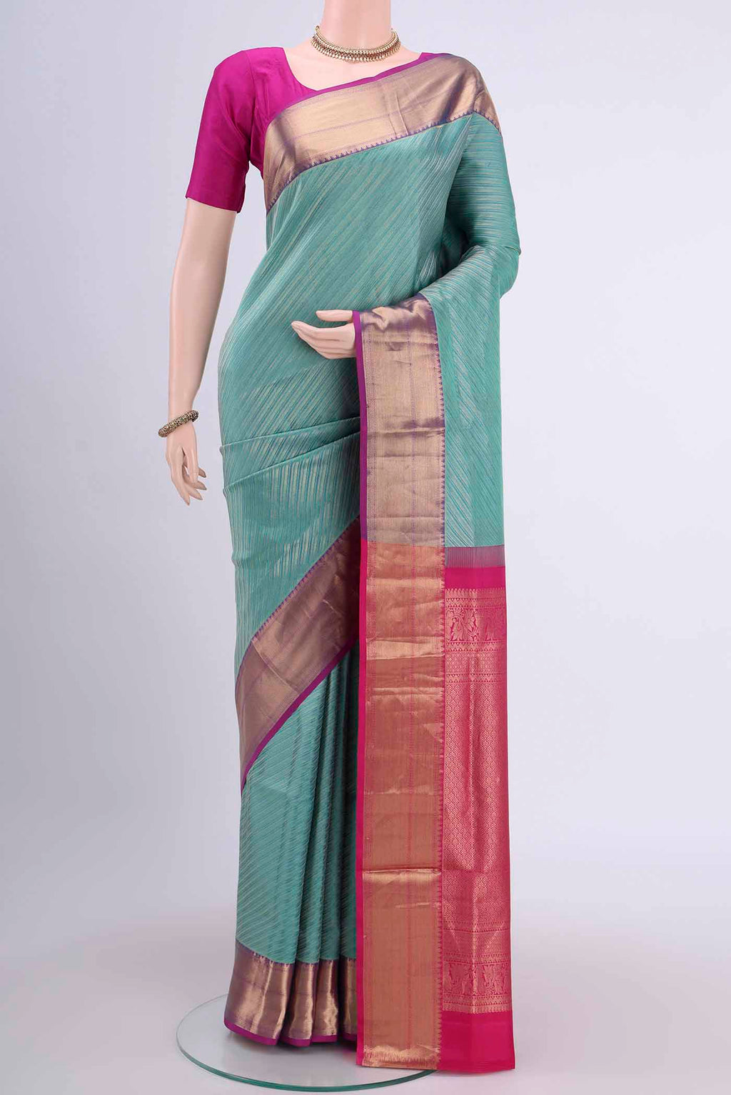 Turquoise Soft Silk Saree with Zari Brocade on the body and Zari Border displayed on a mannequin