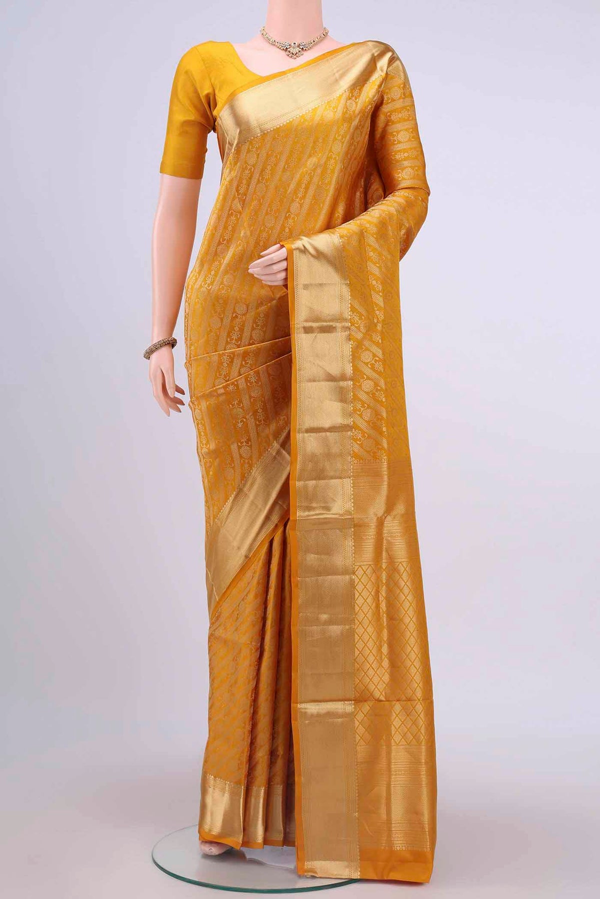 Mustard Dual Tone Soft Silk Saree with Jacquard With Zari Butta on the body and Zari Border displayed on a mannequin
