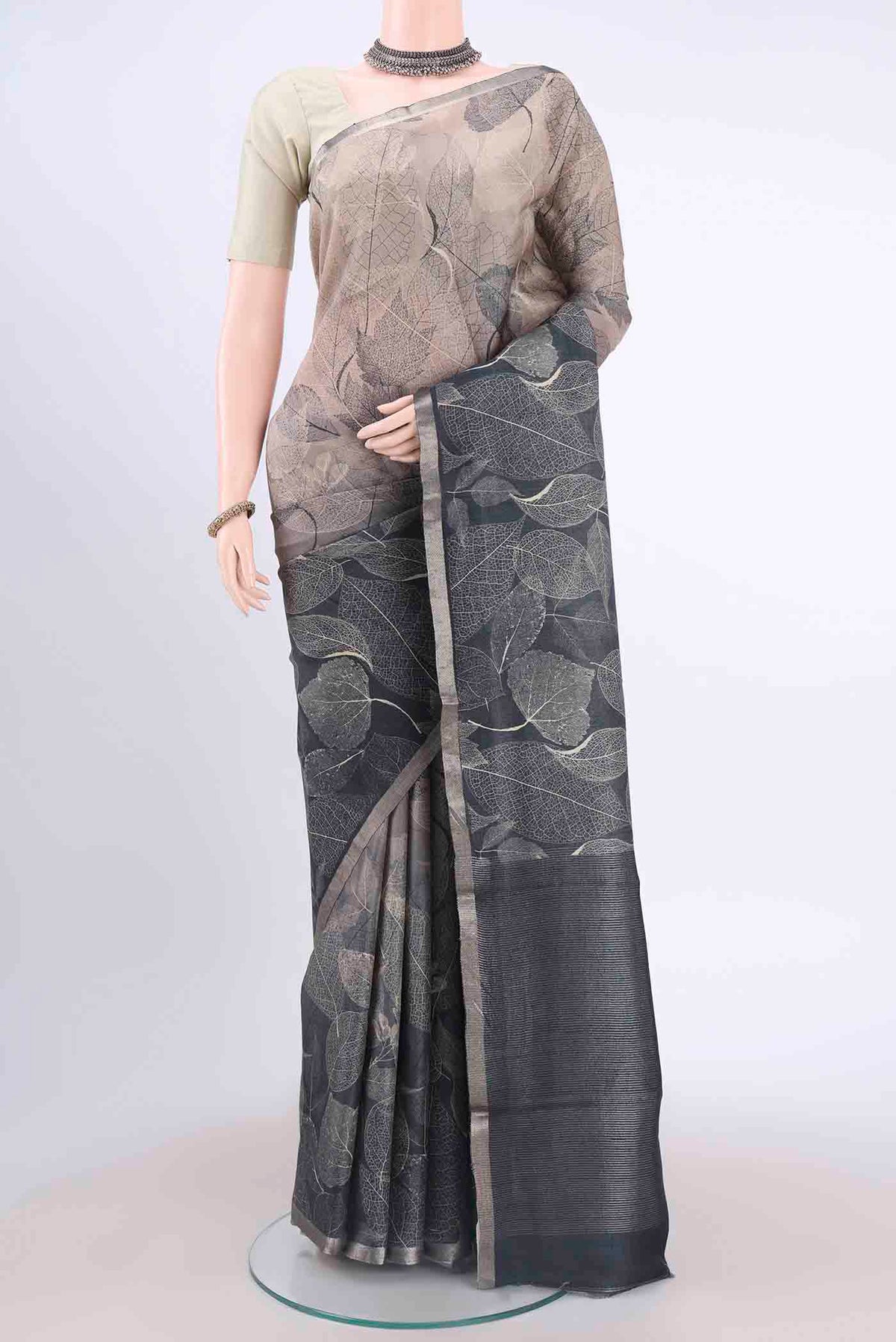 Black Dual Tone Tussar Silk Saree with Floral Print on the body and Zari Border displayed on a mannequin