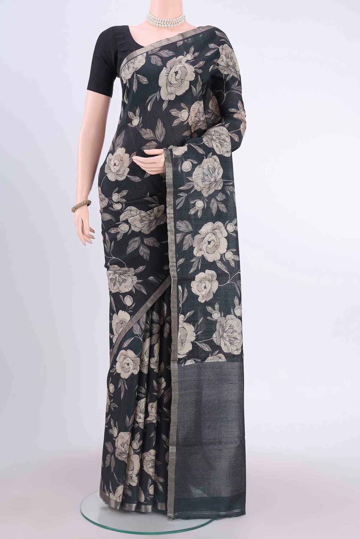 Black Dual Tone Tussar Silk Saree with Floral Print on the body and Zari Border displayed on a mannequin