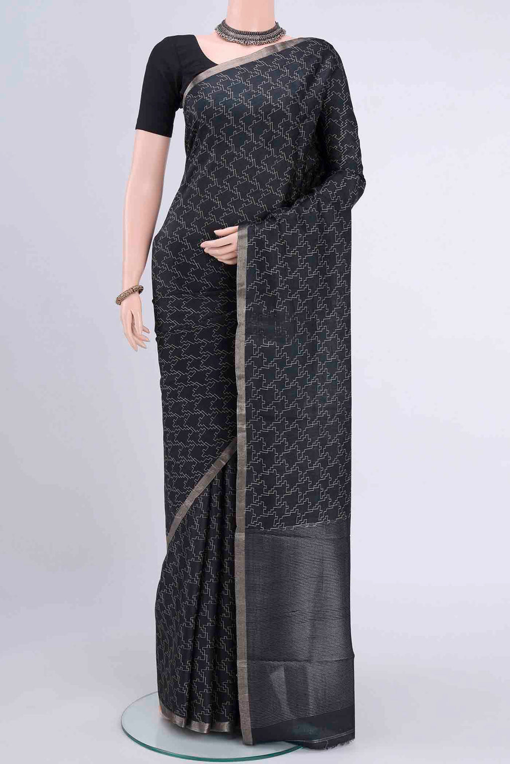 Black Dual Tone Tussar Silk Saree with Geometric Print on the body and Zari Border displayed on a mannequin
