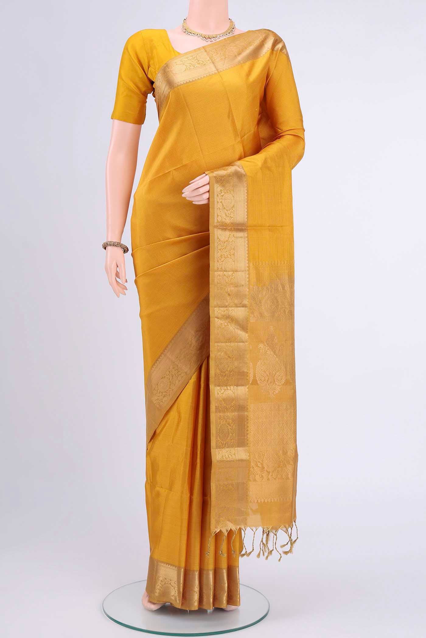 Yellow Soft Silk Saree with Checked design on the body and Zari Border displayed on a mannequin