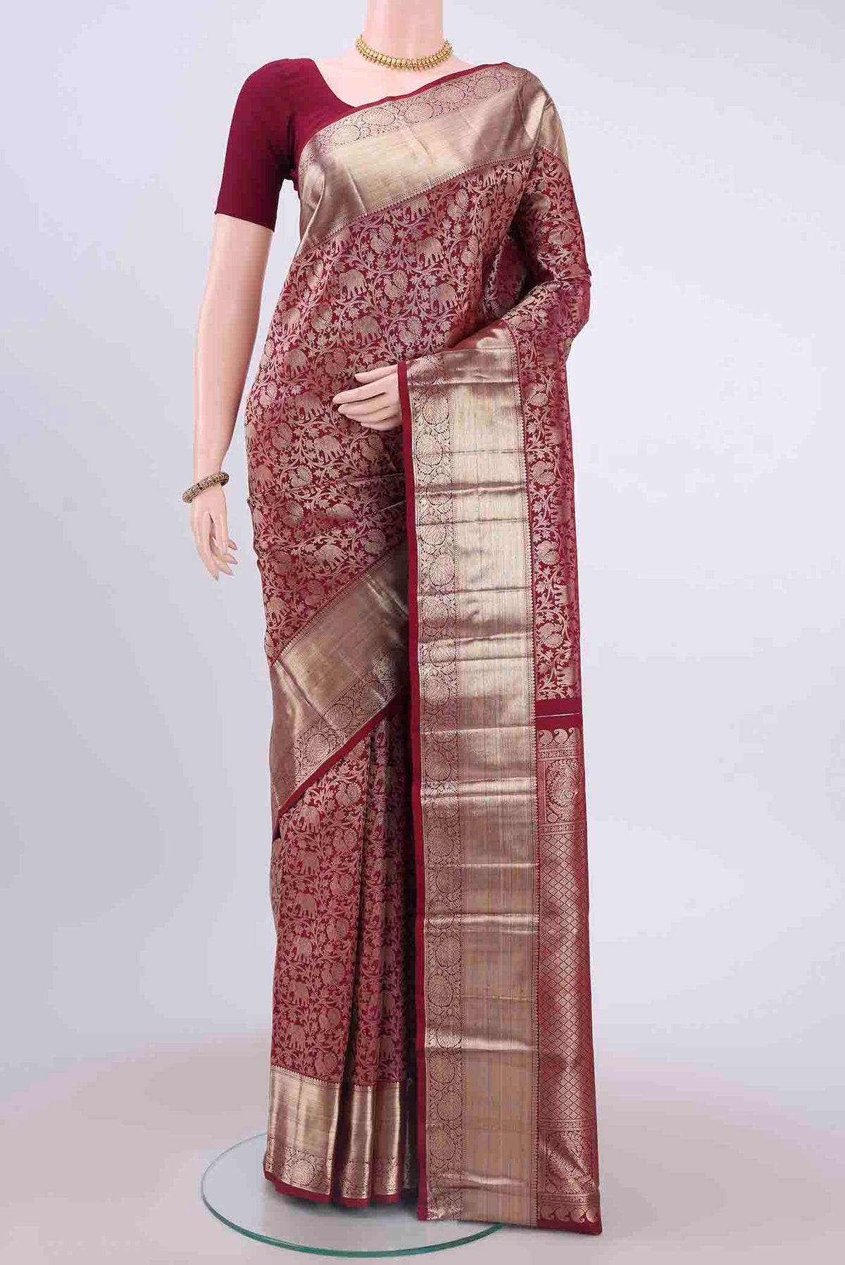 Maroon Kanchipuram Saree with Zari Brocade on the body and Zari Border displayed on a mannequin