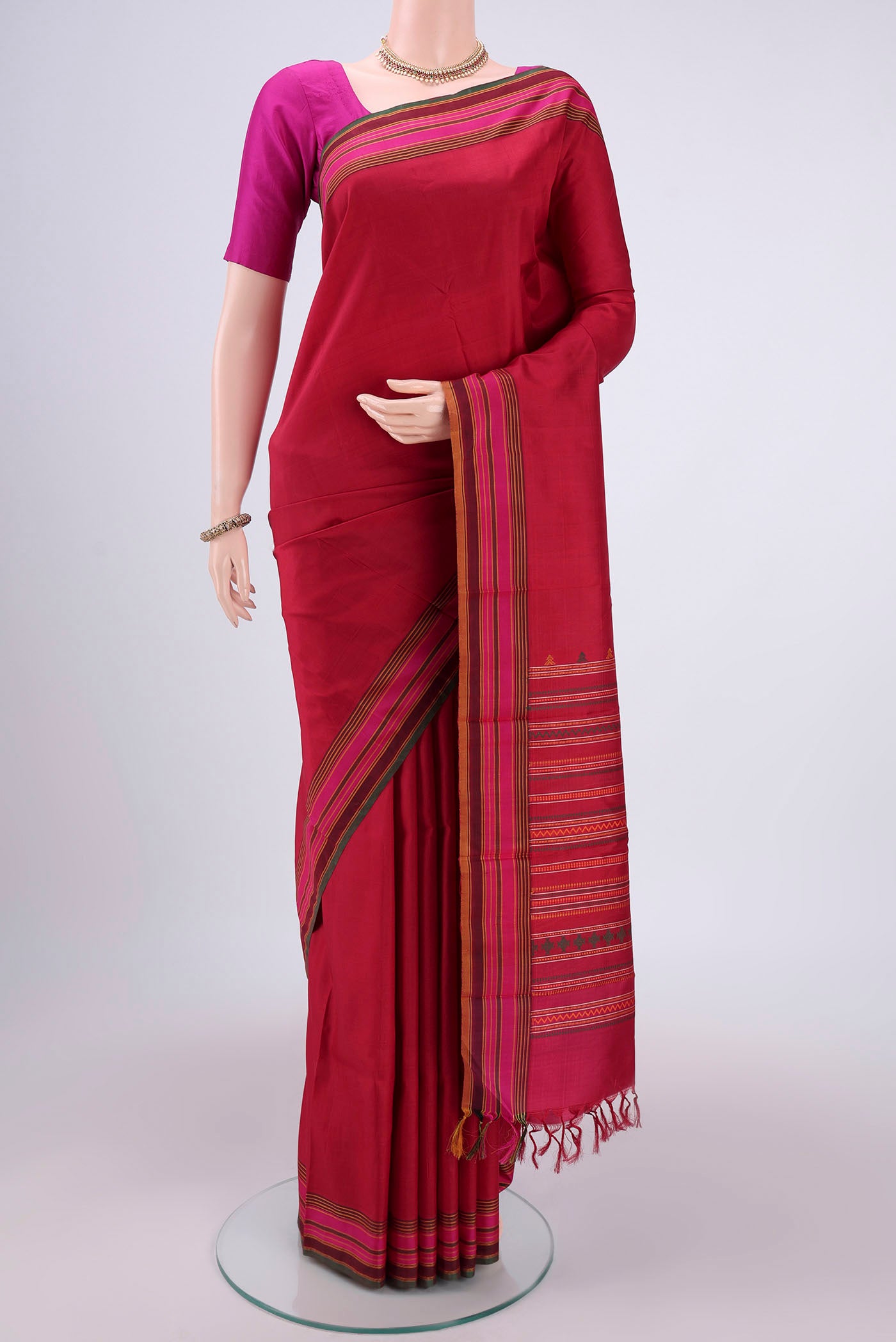 Maroon Kanjivaram Saree with Checked design on the body and Thread Border.  displayed on a mannequin