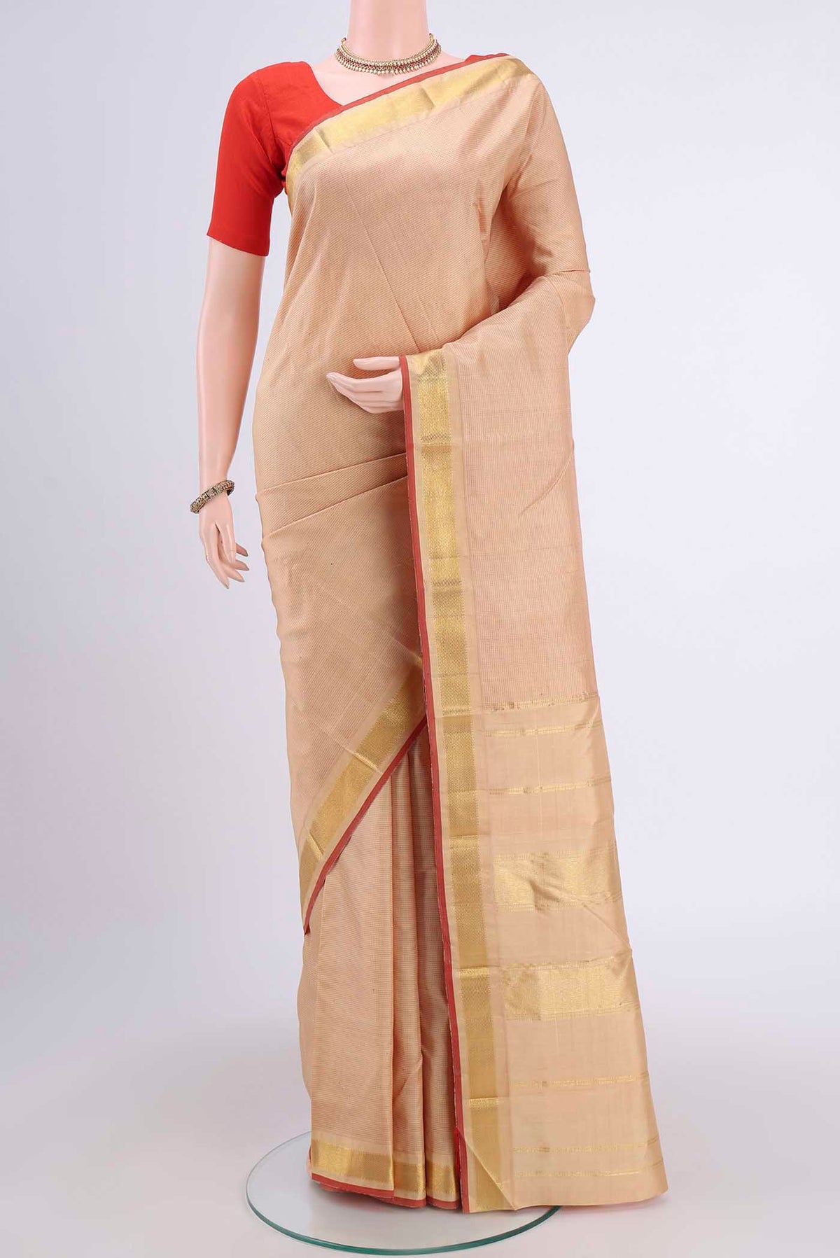 Beige Kanchipuram Saree with Stripes on the body and Zari Border displayed on a mannequin