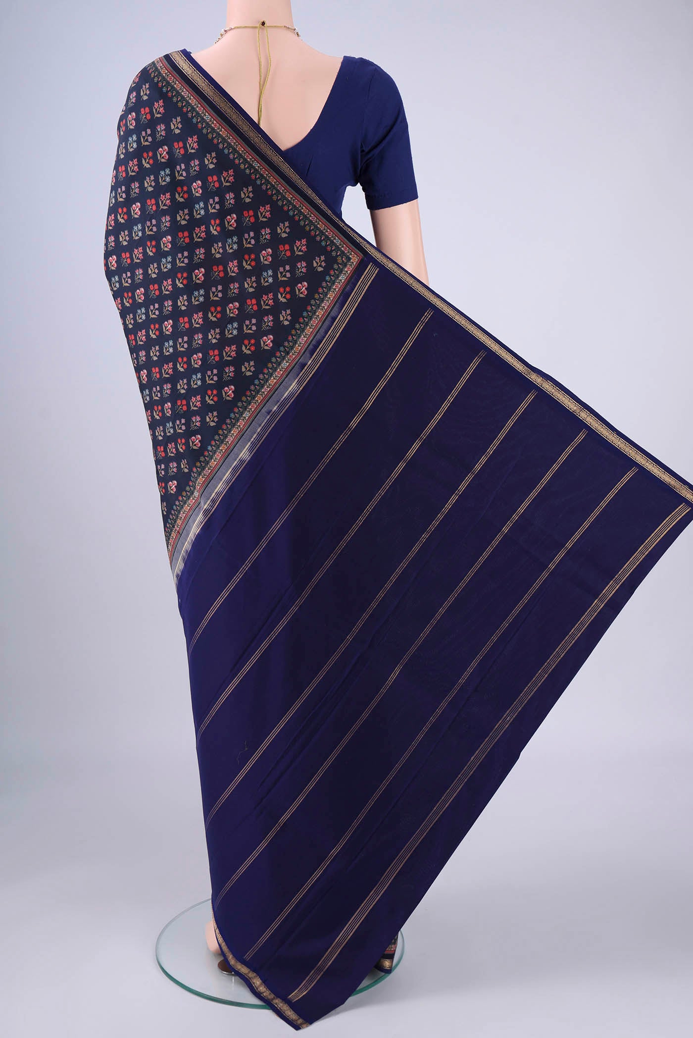 Flat view of Navy Blue Printed Silk Saree with Printed design on the body and Zari Border. 