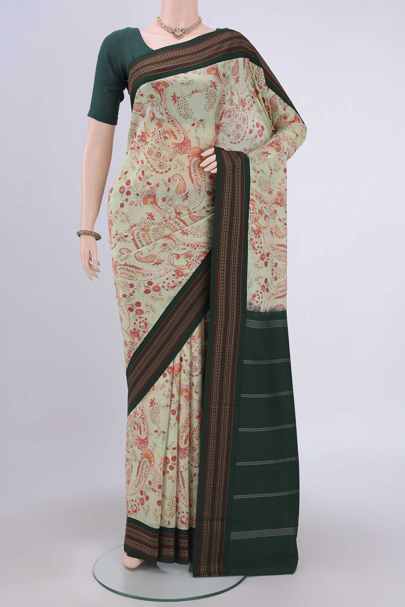 Sage Green Printed Silk Saree with Floral Print on the body and Thread Border.  displayed on a mannequin