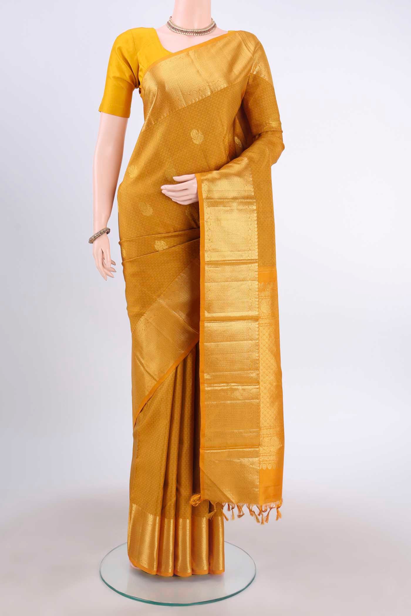 Pure Silk Pure Zari Mustard Kanchipuram Saree with Jacquard With Zari Butta on the body and Zari Border displayed on a mannequin