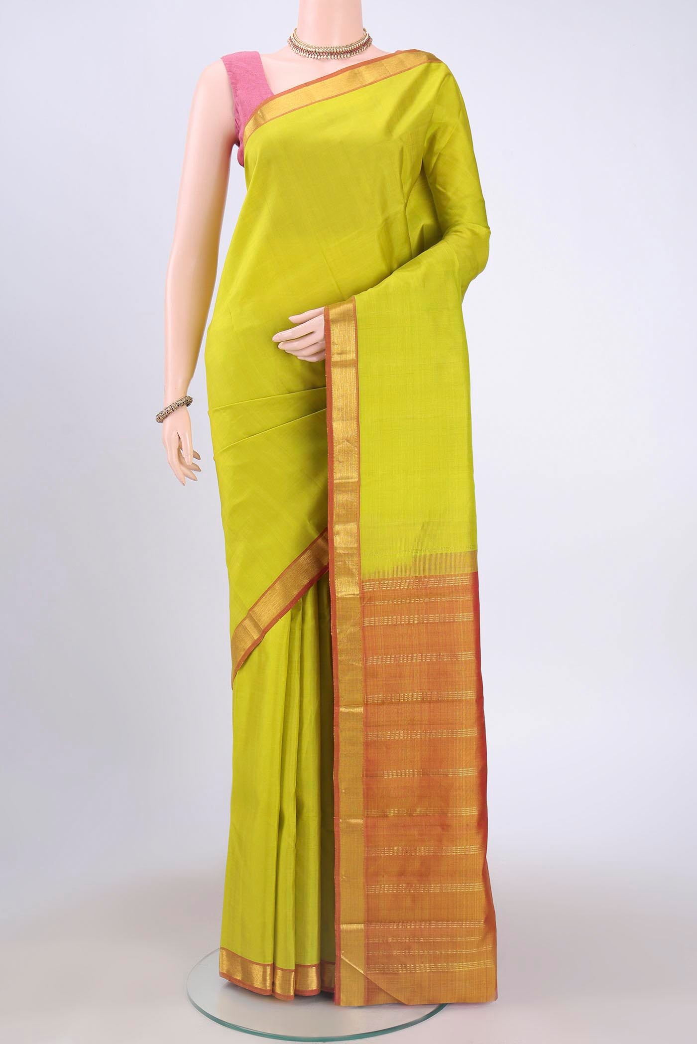 Acid Green Kanchipuram Saree with Plain Body and Zari Border displayed on a mannequin