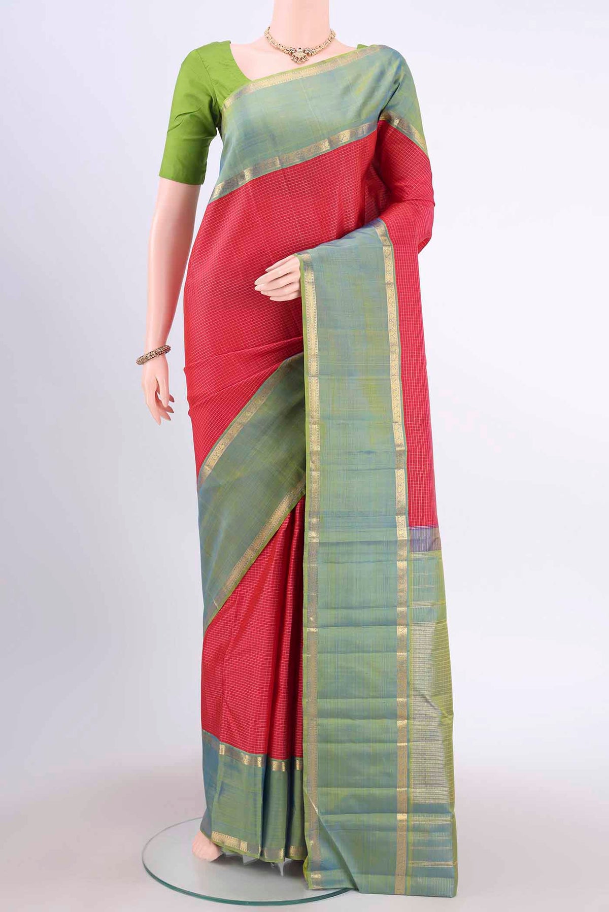Red Kanchipuram Silk Saree with Checked design on the body and Zari Border displayed on a mannequin