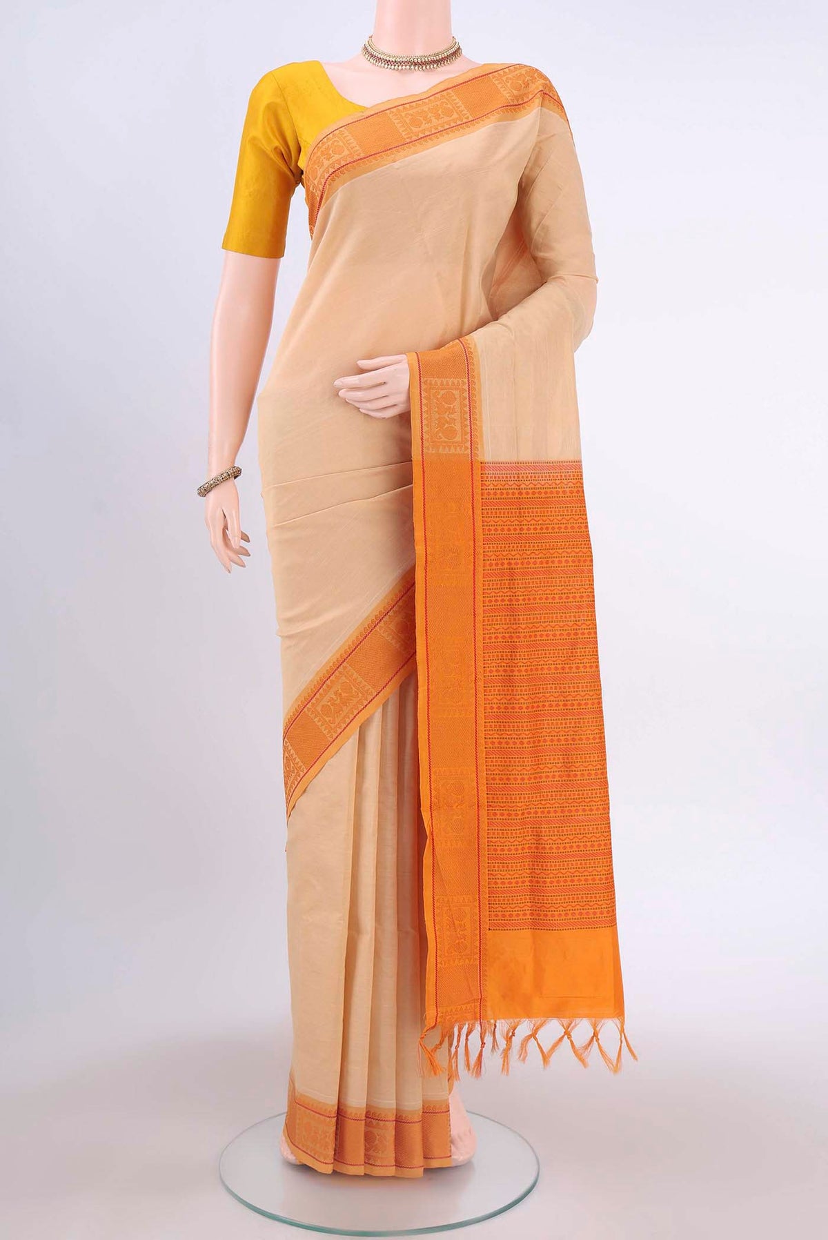 Beige Poly Cotton Saree with Plain Body and Thread Border displayed on a mannequin