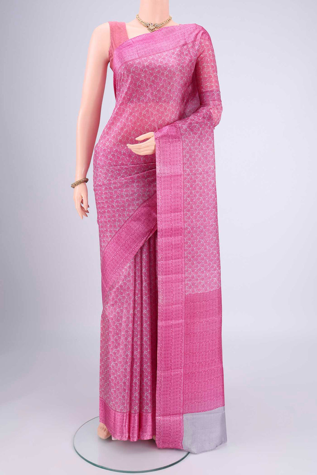 Grey Printed Silk Saree with Floral Print on the body and Printed Border.  displayed on a mannequin