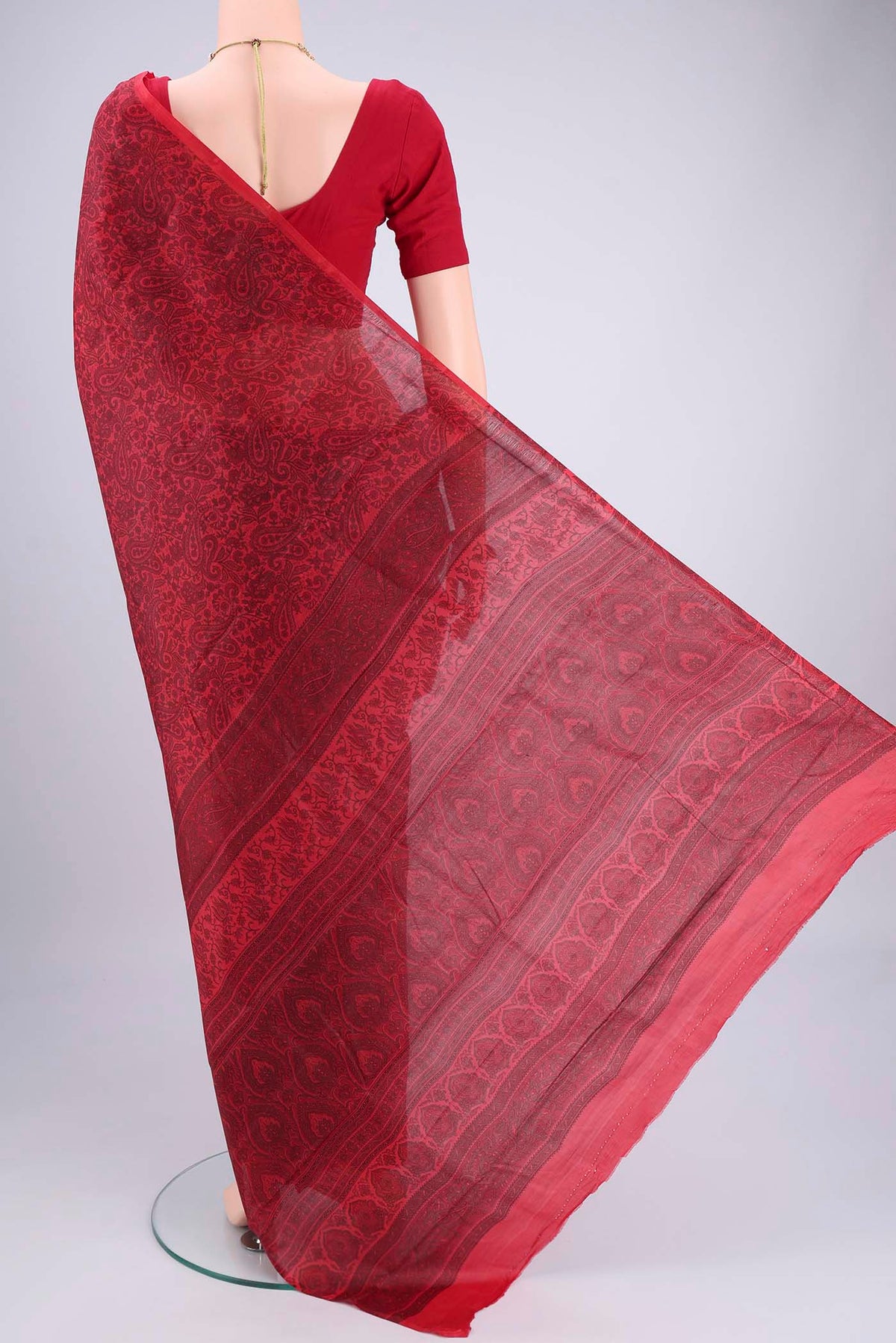 Flat view of Red Printed Silk Saree with Floral Print on the body and Printed Border. 