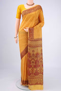 Mustard Printed Silk Saree with Floral Print on the body and Printed Border.  displayed on a mannequin